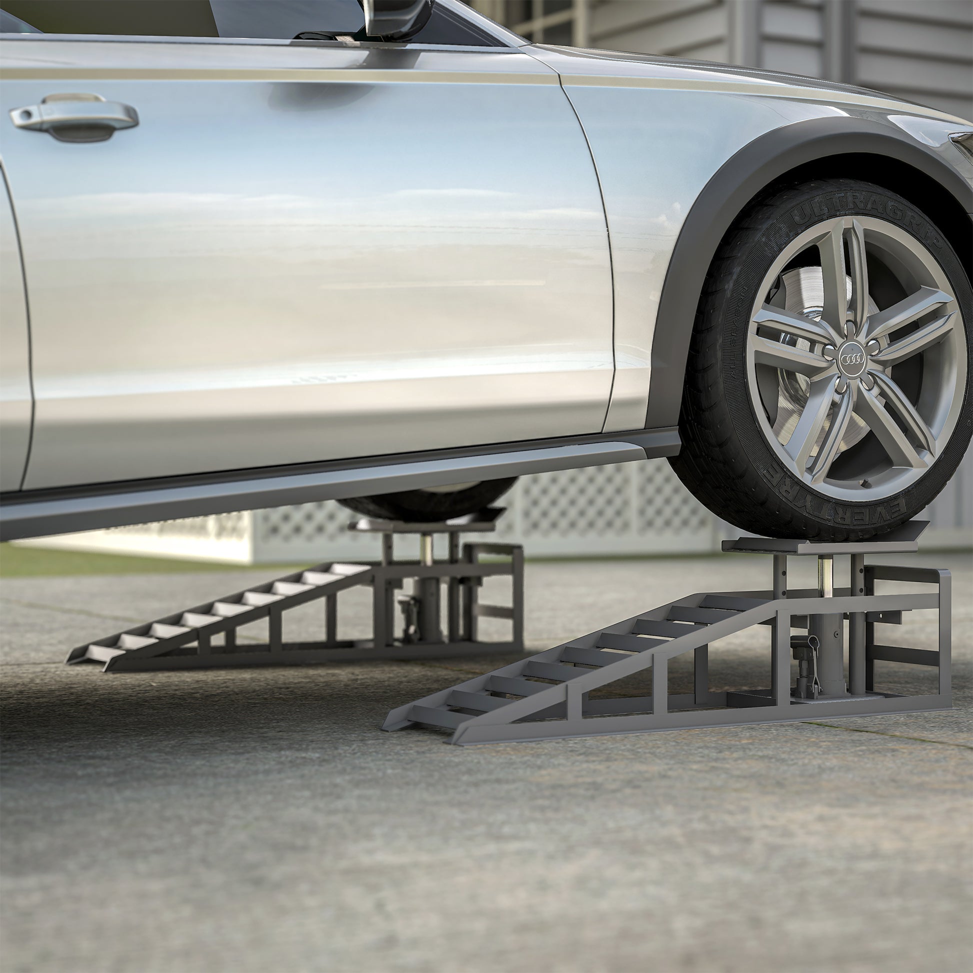 Heavyduty steel car ramps lifting a silver Audi for maintenance