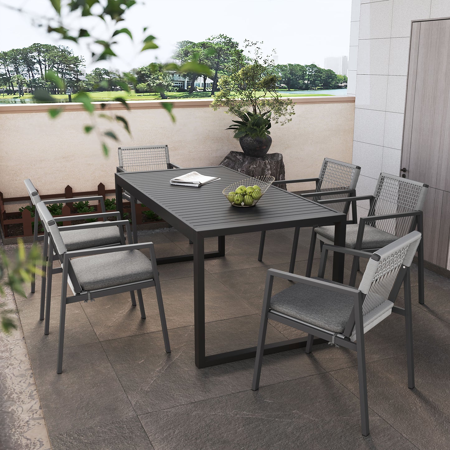 Modern outdoor dining set with dark gray slatted table and wovenback chairs
