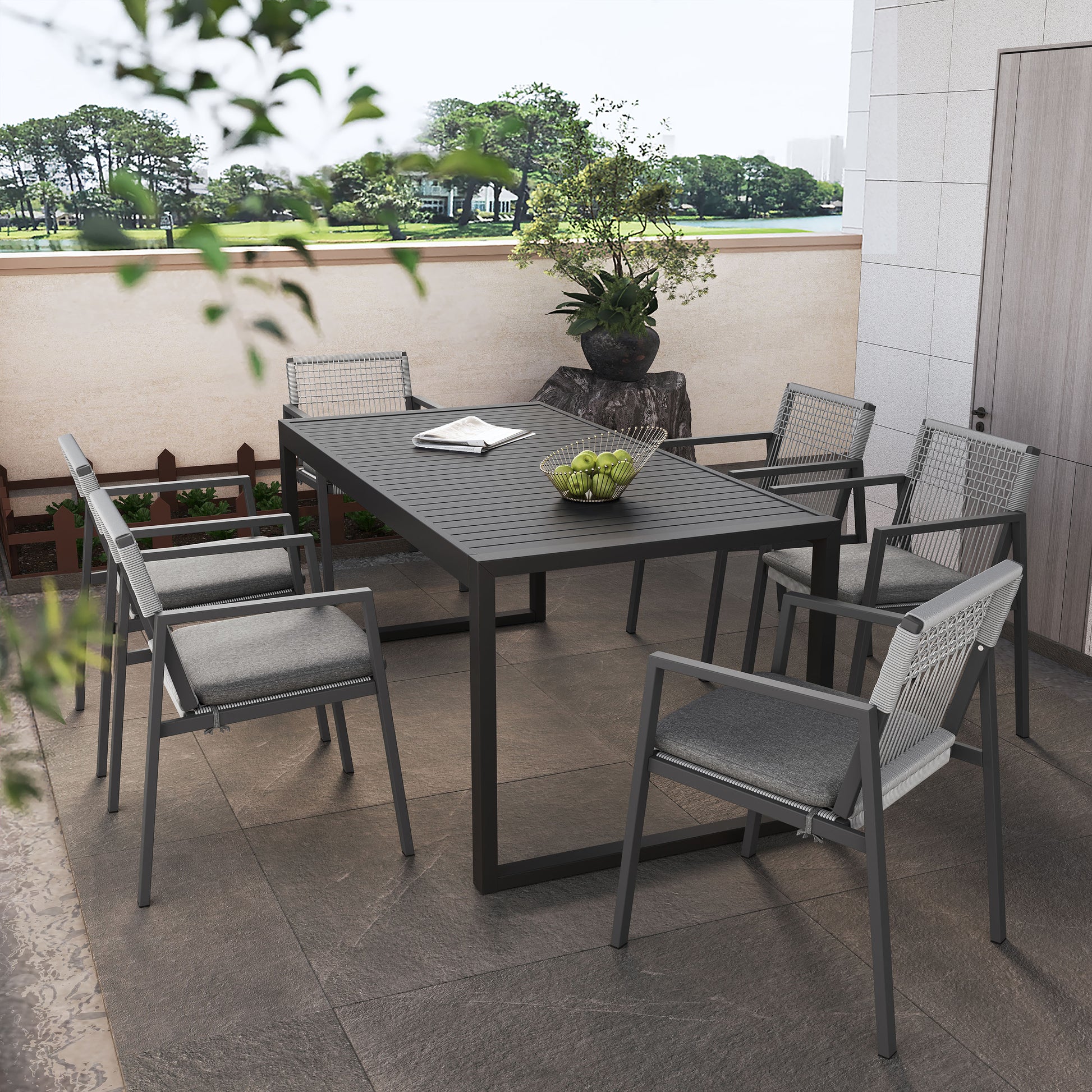 Modern outdoor dining set with dark gray slatted table and wovenback chairs