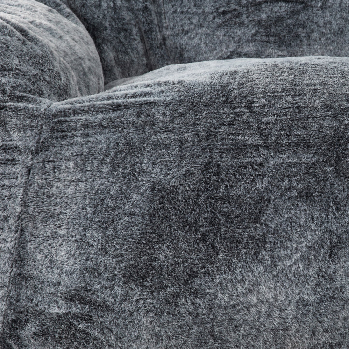 Closeup of a plush grey faux fur bean bag chair emphasizing texture and comfort
