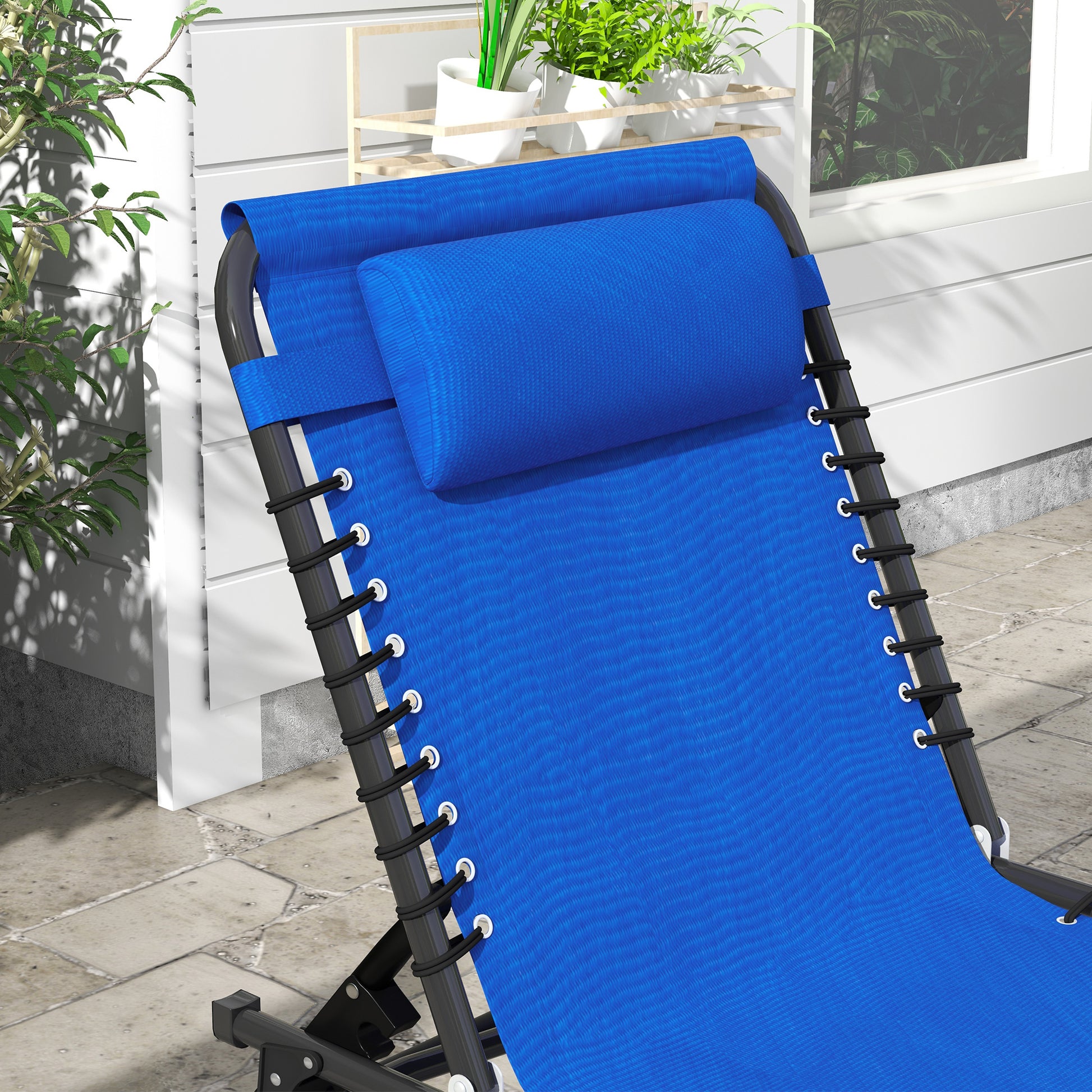Closeup of a blue fabric zero gravity chair with black frame and bungee cords