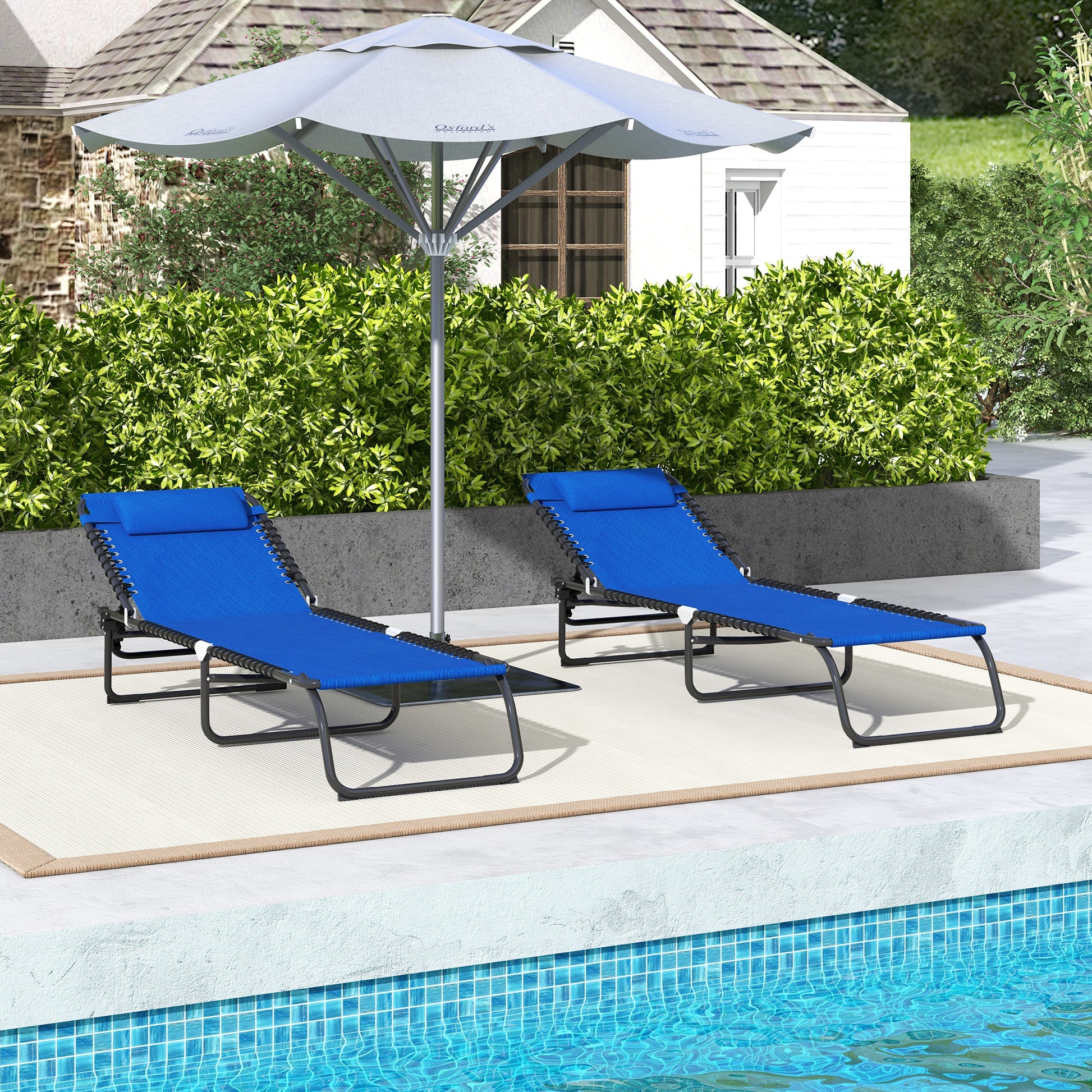 Two blue zero gravity chairs with black frames and headrests ideal for poolside lounging