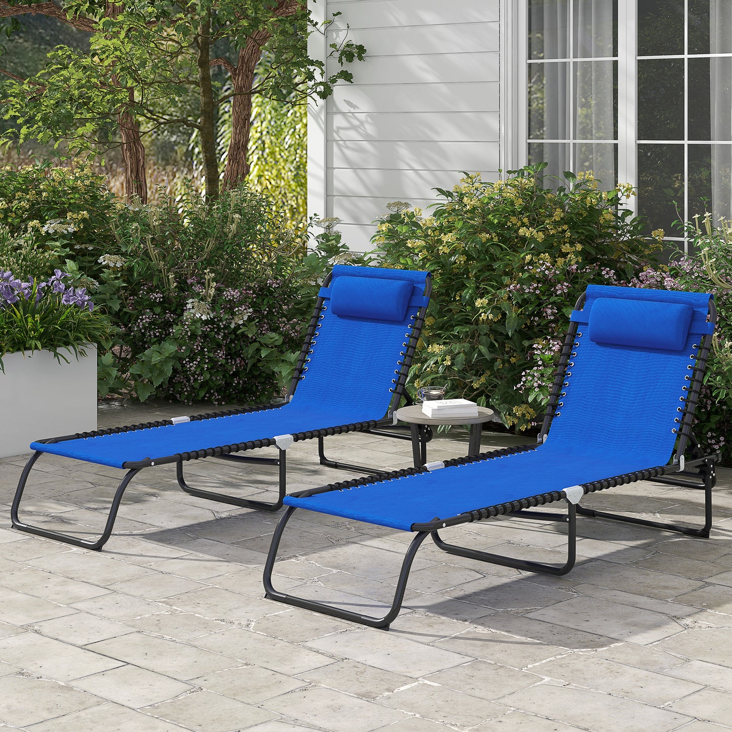Two blue zero gravity chairs with headrests on a patio