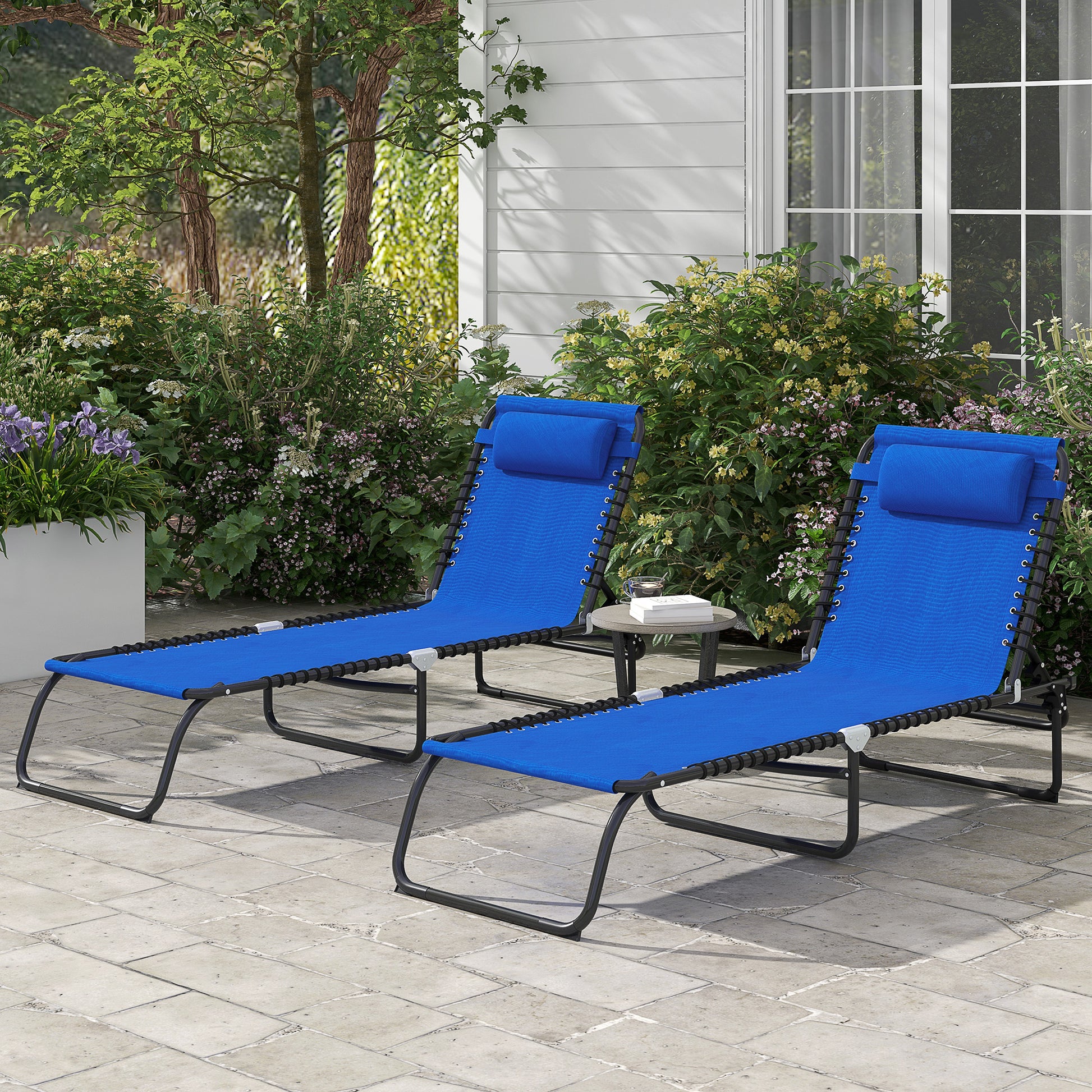 Two blue zero gravity chairs with headrests on a patio