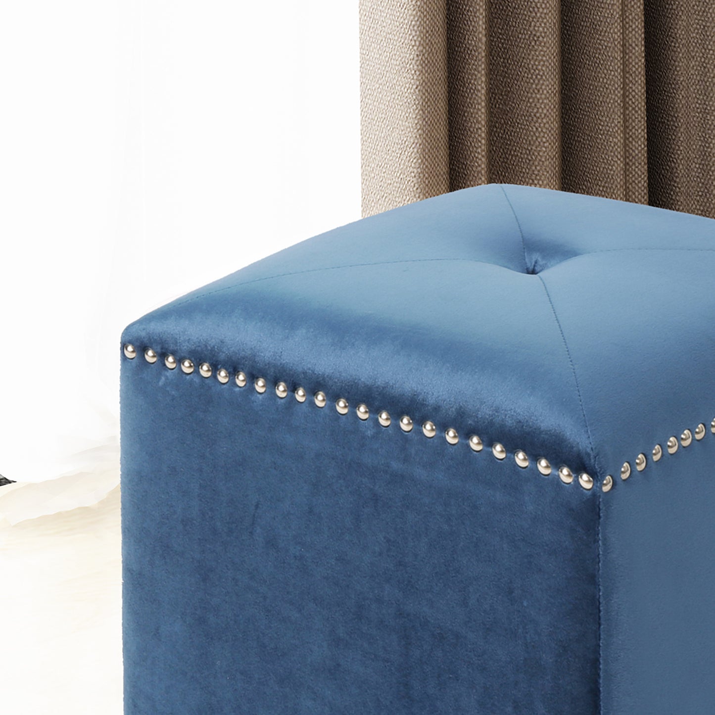 Blue velvet ottoman with silver nailhead trim