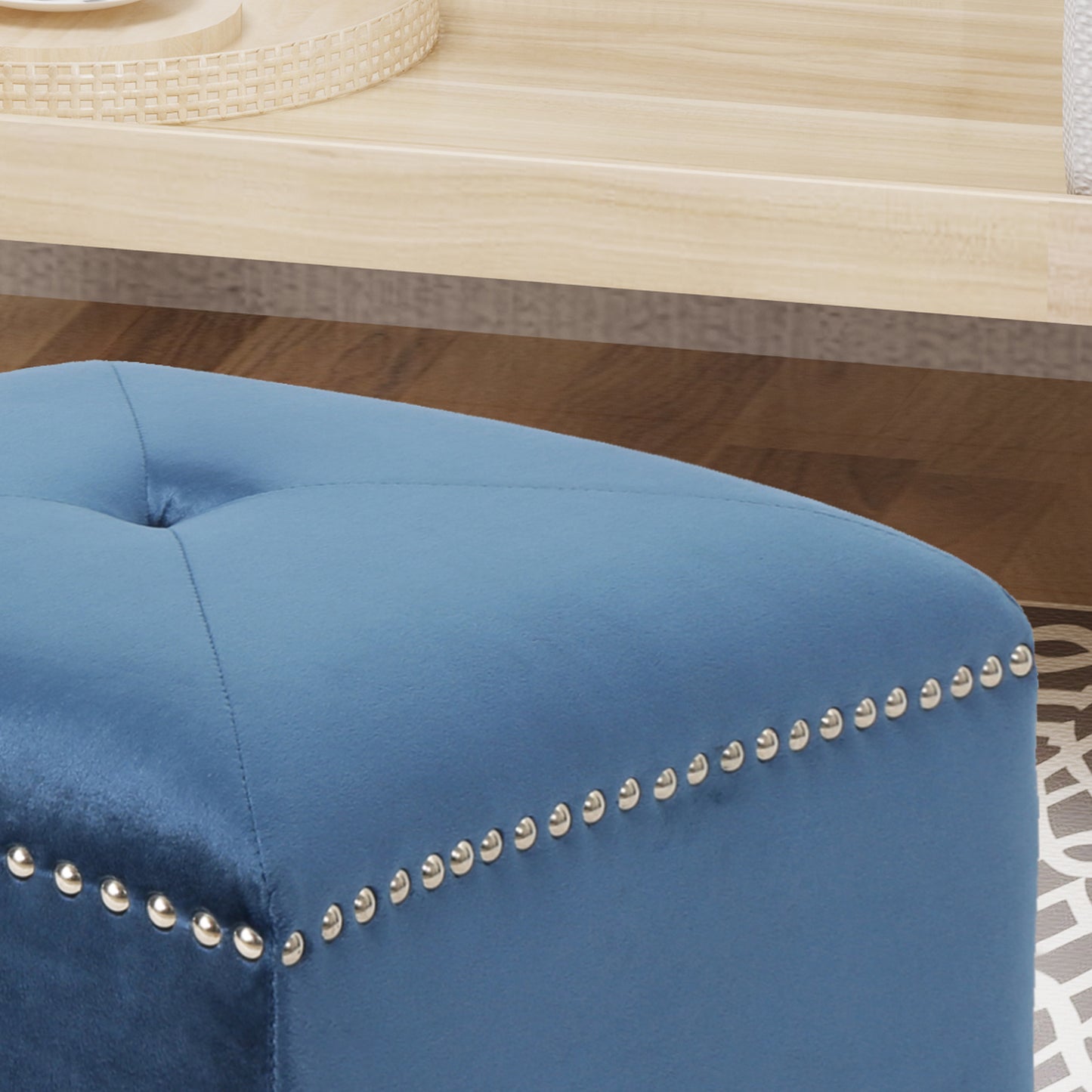 Tufted blue velvet ottoman with silver nailhead trim for stylish home decor