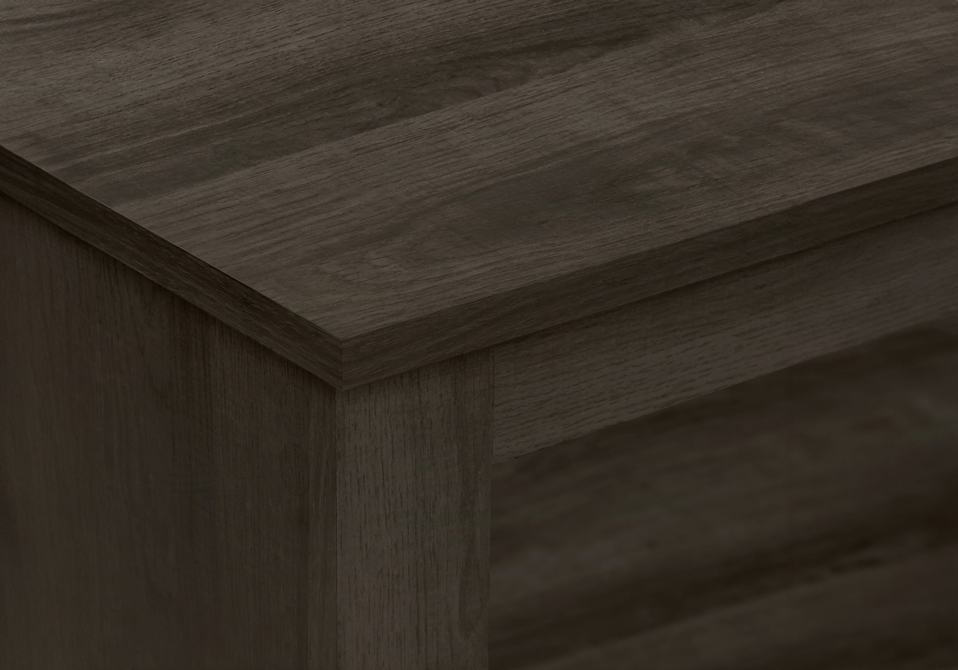 Closeup of a dark oak wood shelfs grain and edge