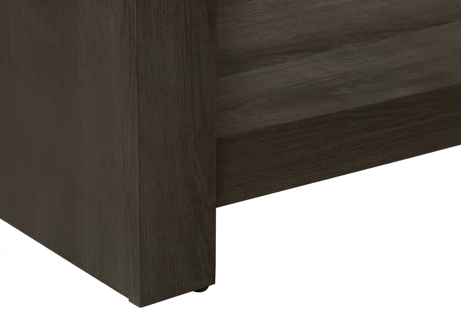 Dark gray wood grain laminate shelf edge with textured detail part of modern furniture