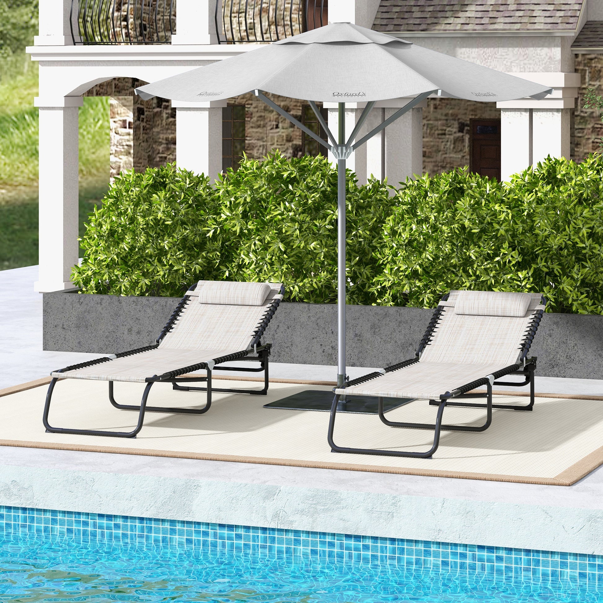Two beige outdoor chaise lounge chairs with adjustable headrests sit by a pool