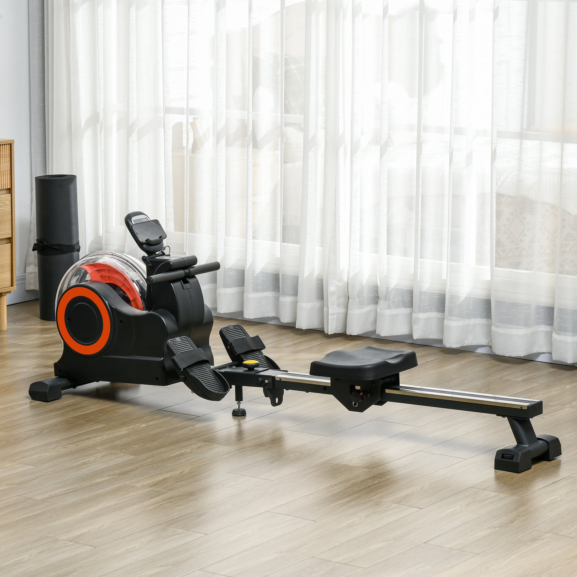 Black and orange water rowing machine with adjustable foot straps and digital monitor for home gym