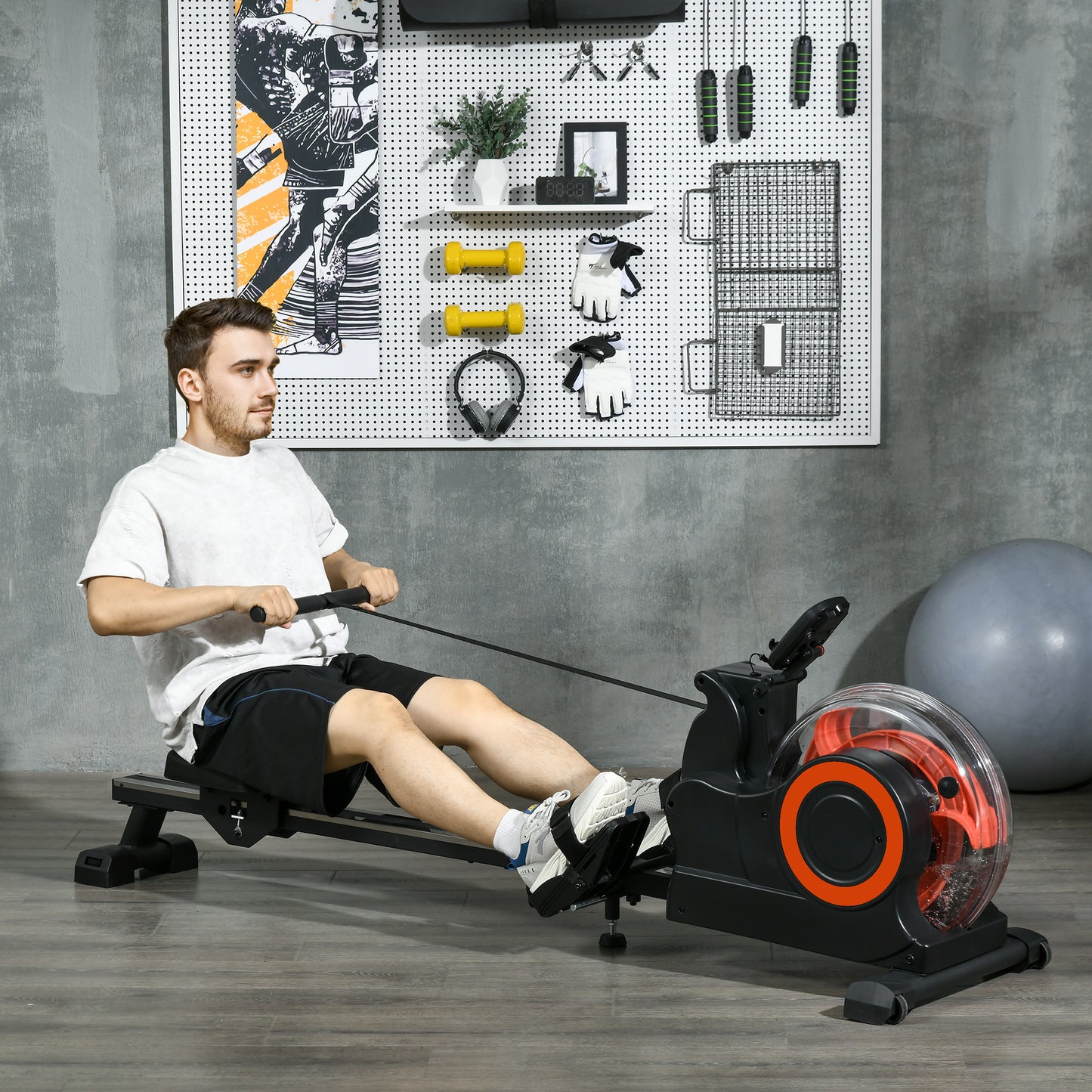 Man rowing on black and orange water resistance machine