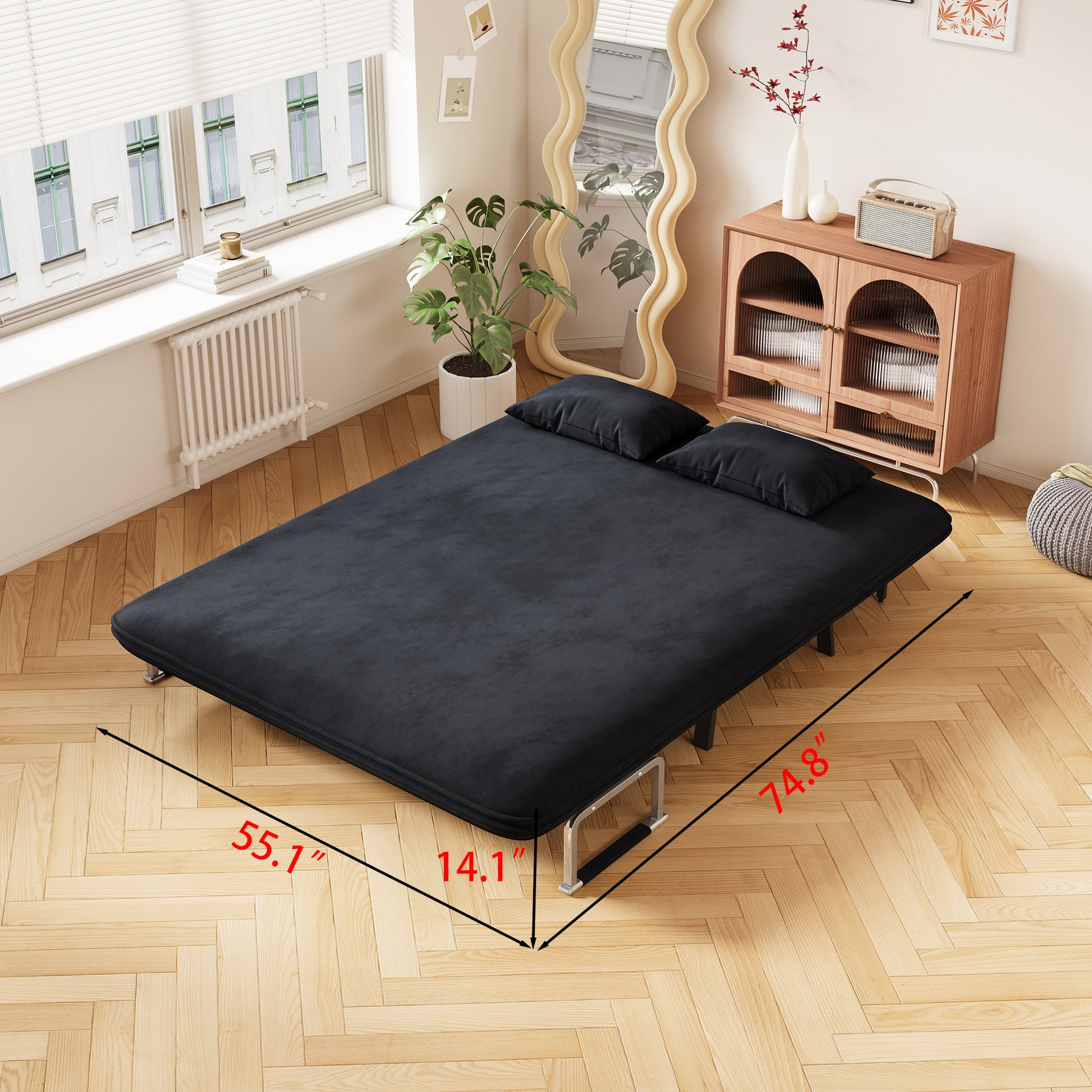 Black velvet futon sofa bed with chrome legs and two throw pillows