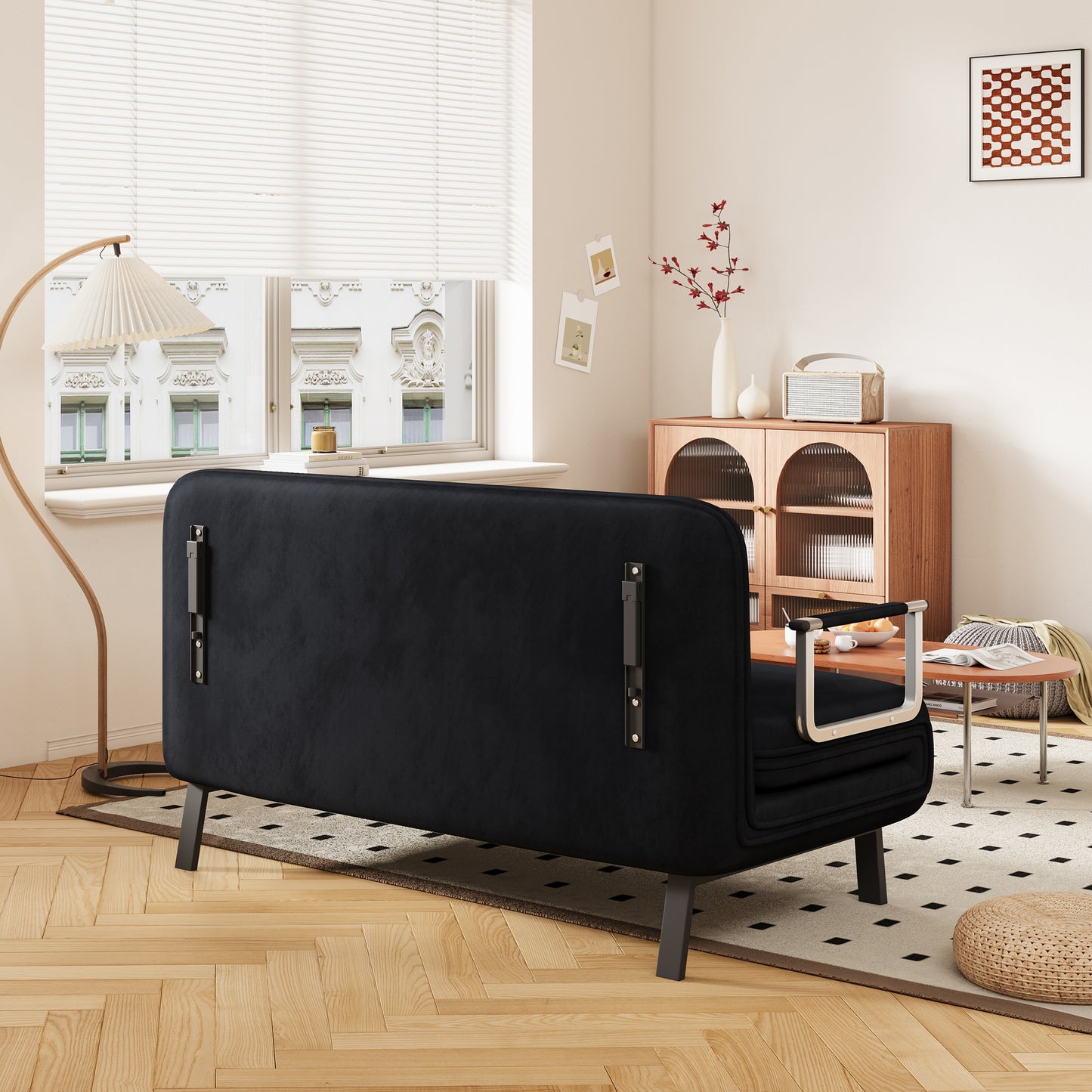 Black velvet sofa with modern metal legs and armrests