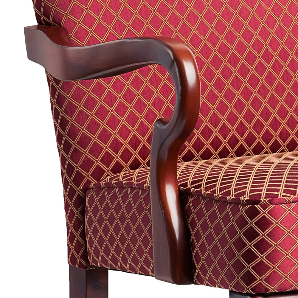 Elegant red damask wingback chair with curved mahogany armrests