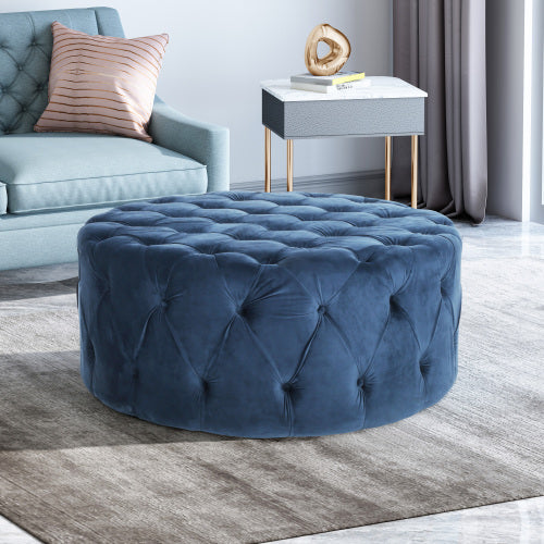 Deep blue velvet tufted ottoman a stylish centerpiece for modern living rooms