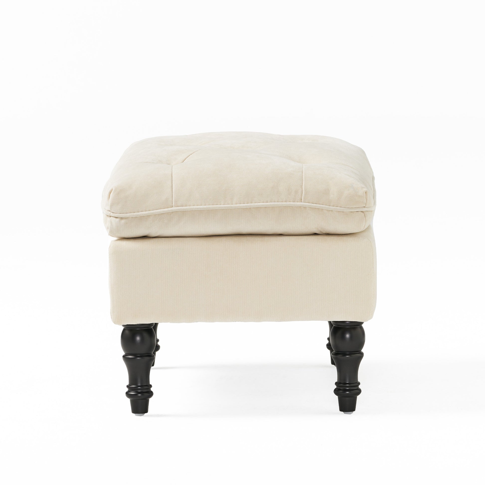 Cream tufted velvet ottoman with carved dark wood legs