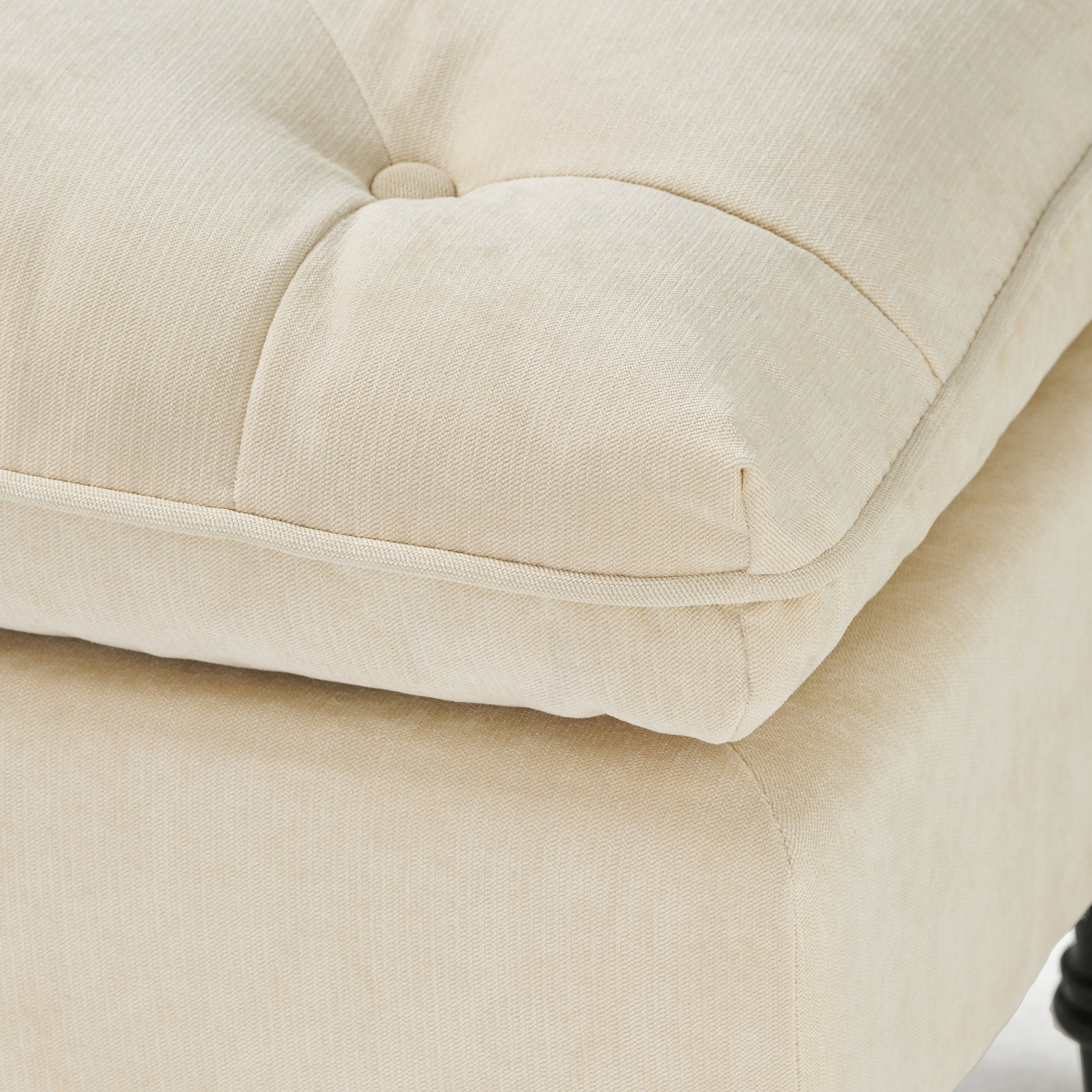 Tufted cream linen ottoman cushion with piped edge detail