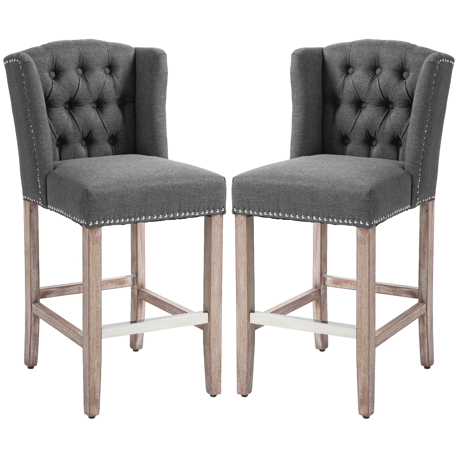 Two grey tufted bar stools with silver nailhead trim and natural wood legs