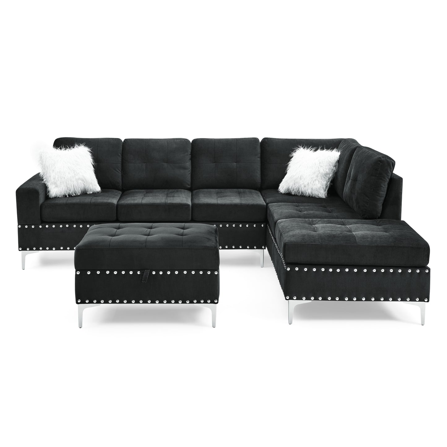 Black sectional sofa with tufted cushions silver nailhead trim and fluffy white accent pillows