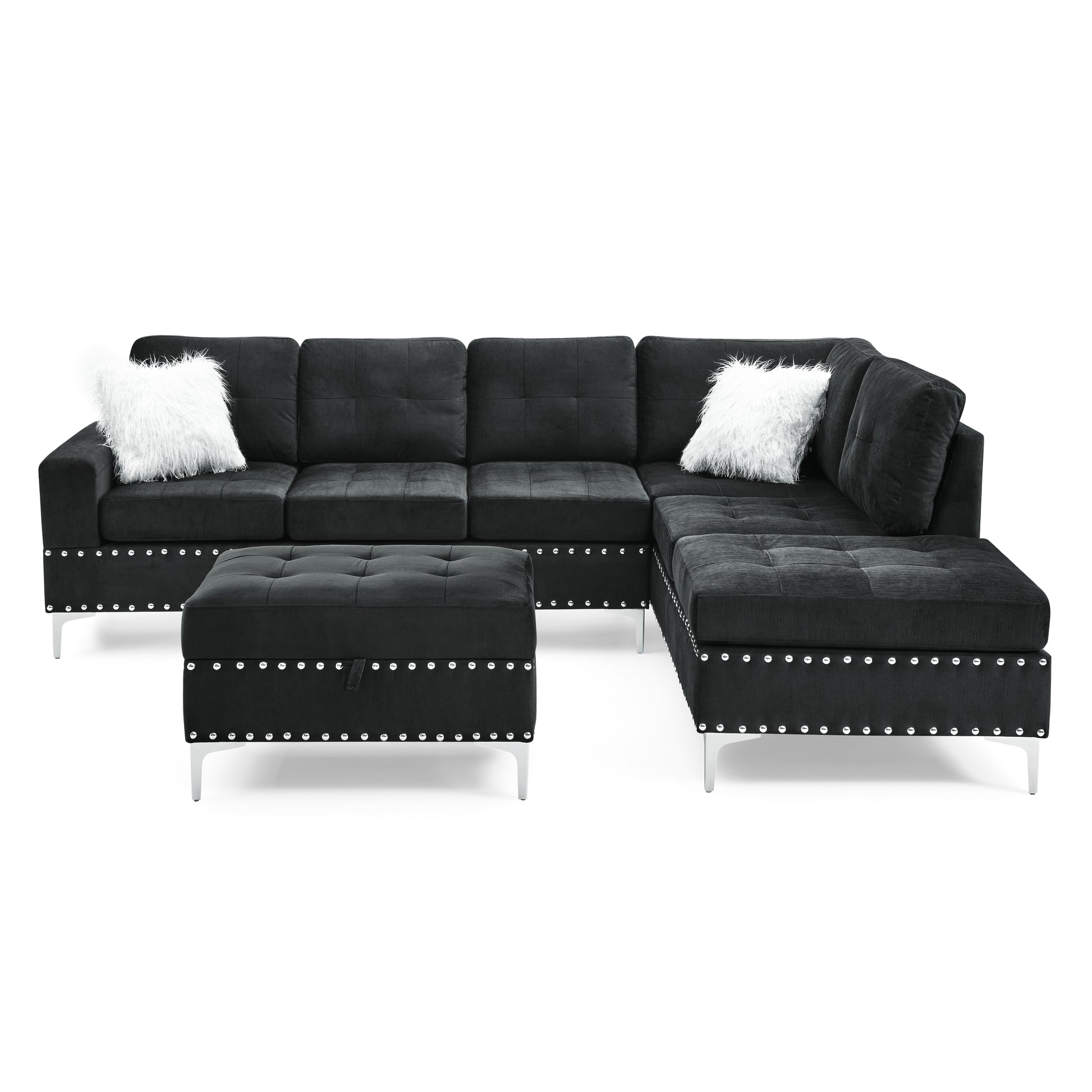 Black sectional sofa with tufted cushions silver nailhead trim and fluffy white accent pillows