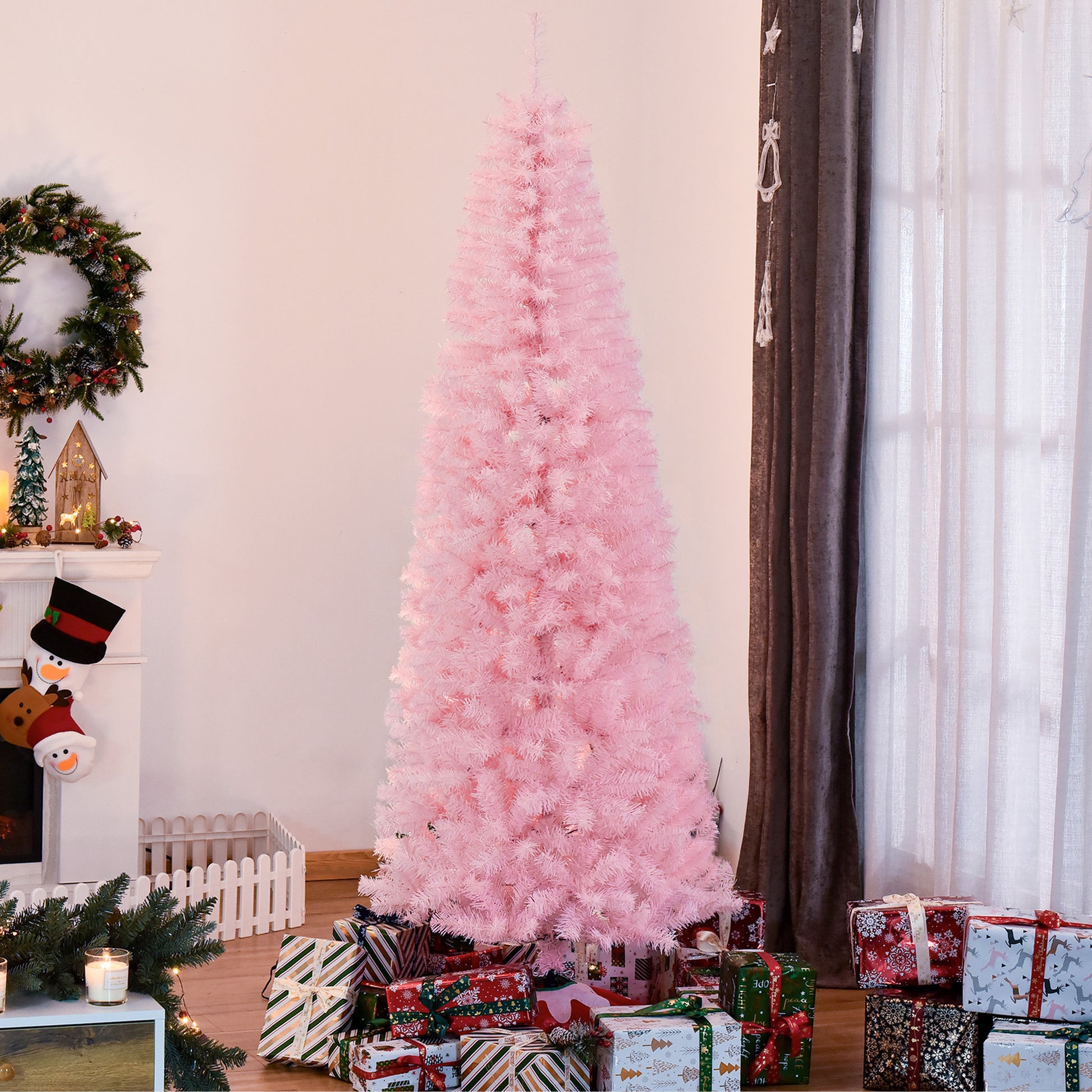 Tall pink artificial Christmas tree with white lights and presents underneath