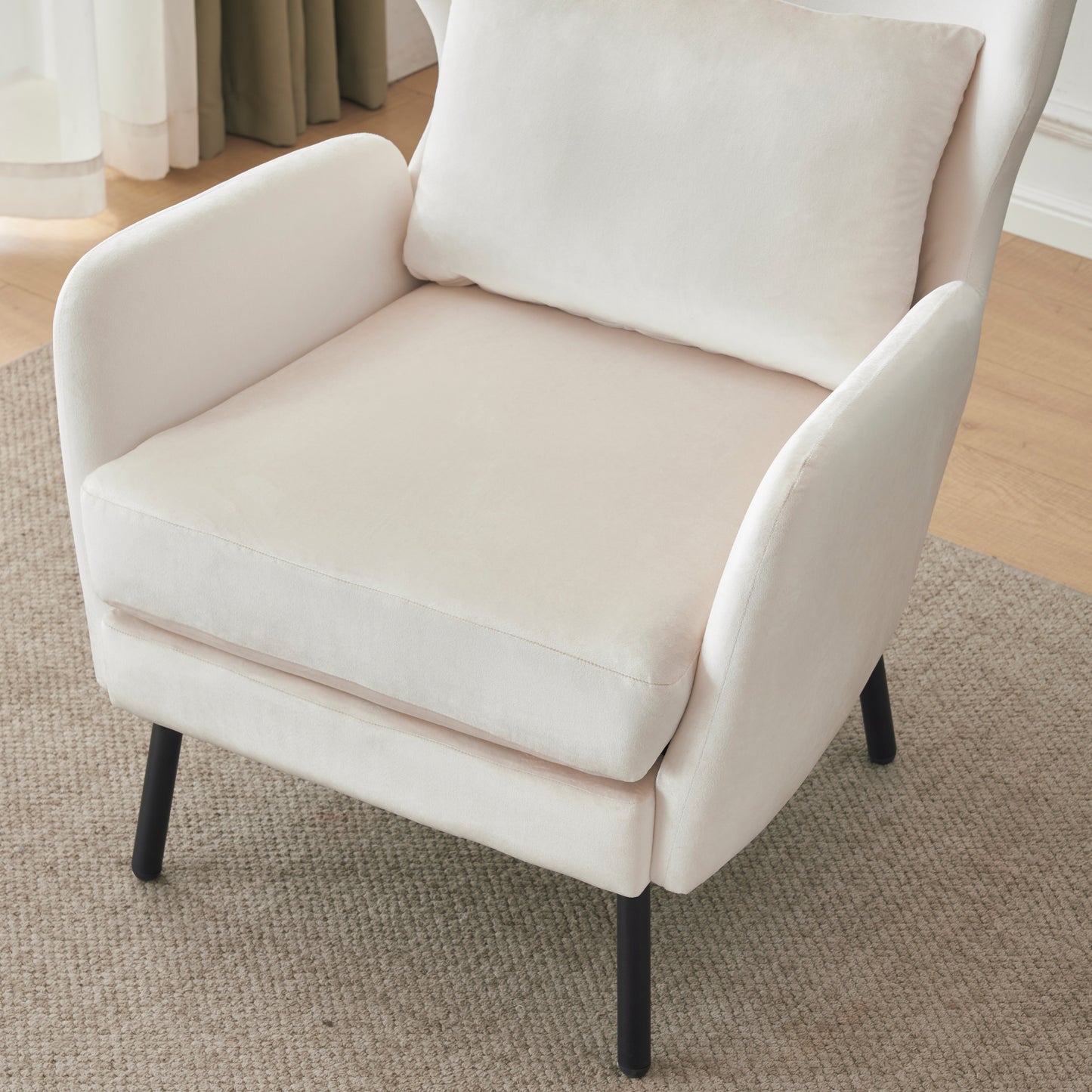 Cream velvet accent chair with black legs and lumbar pillow perfect for reading nooks