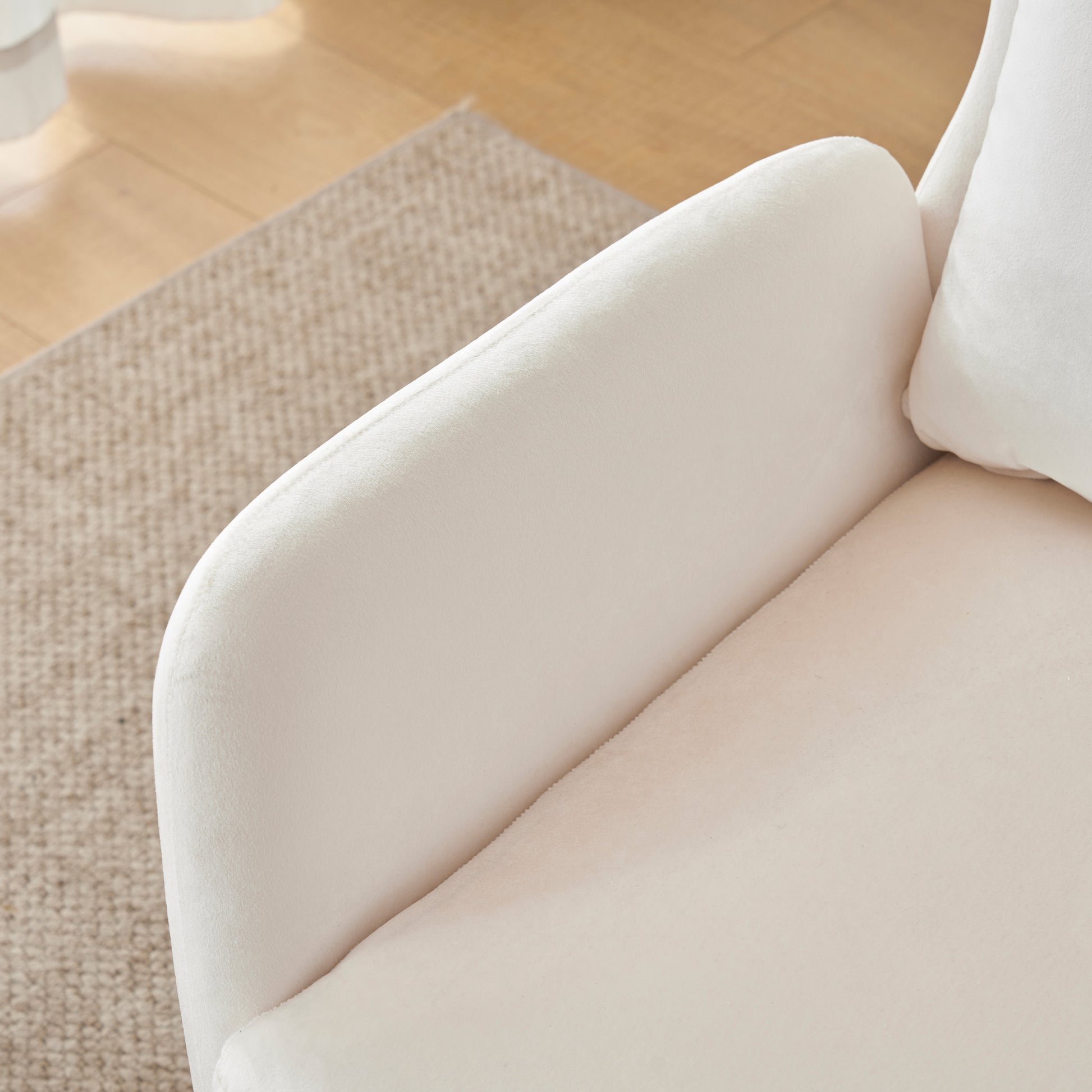 Plush cream boucle fabric armchair armrest and cushion detail