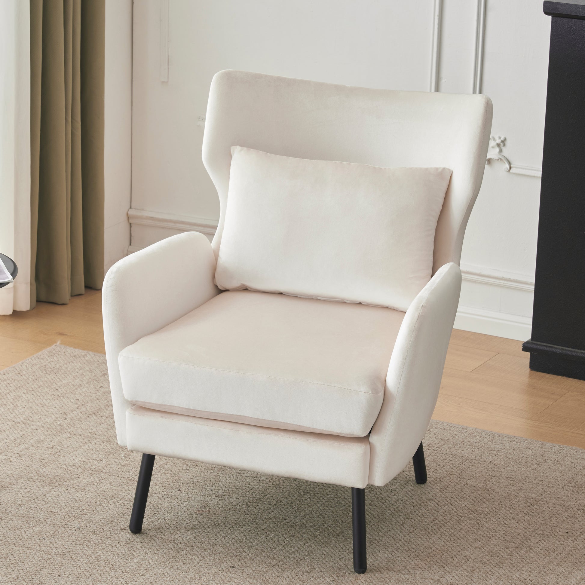 Plush ivory velvet armchair with a matching throw pillow perfect for a cozy reading nook