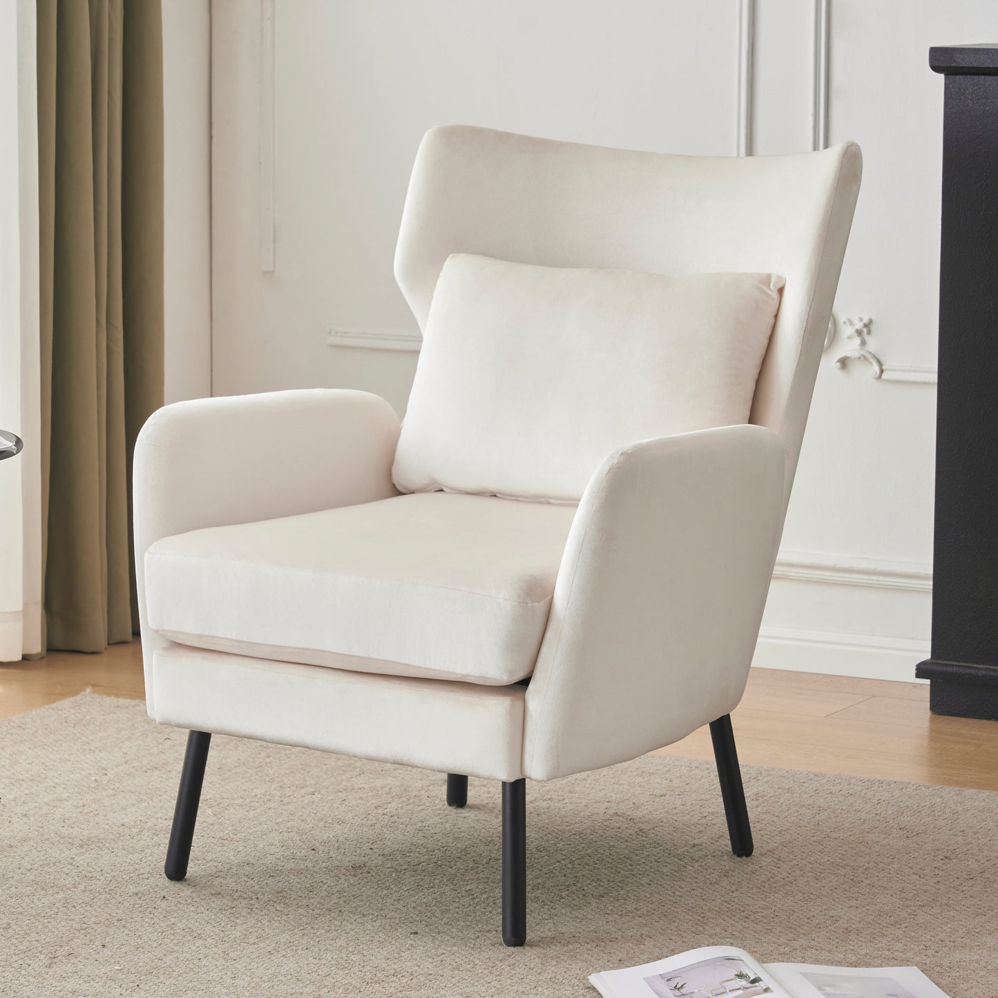 Cream velvet armchair with a tall back plush seat cushion and accent pillow