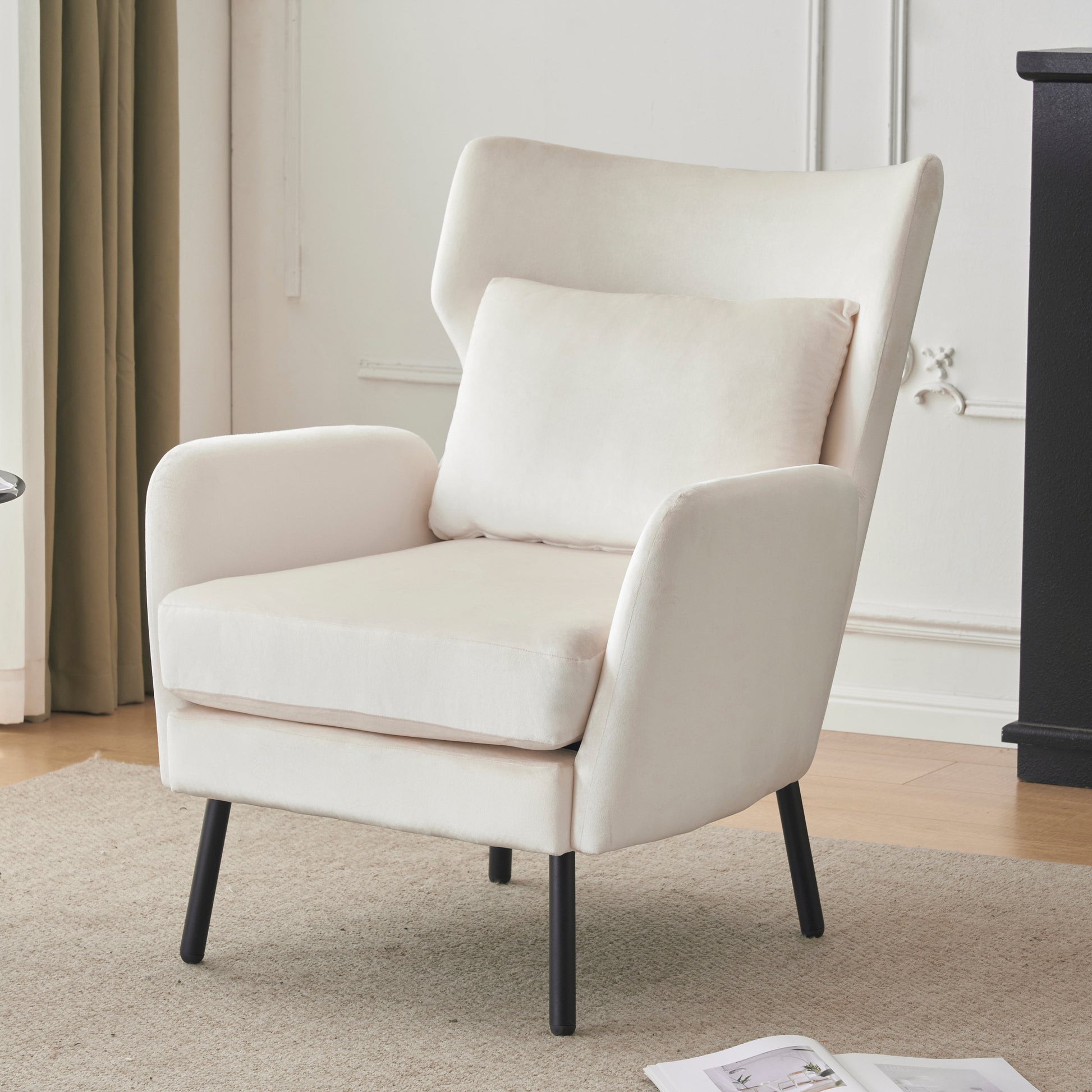 Cream velvet armchair with a tall back plush seat cushion and accent pillow