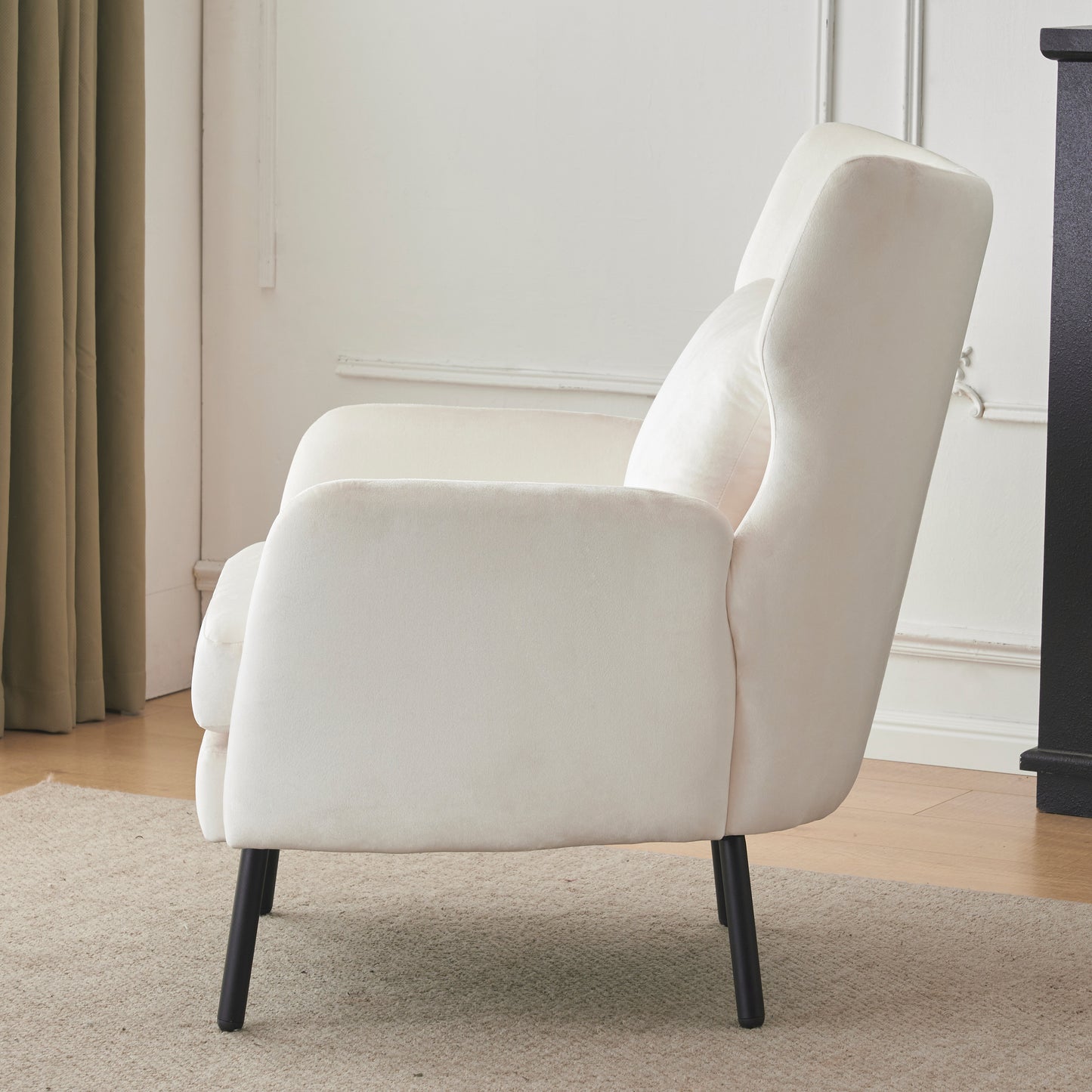 Plush cream velvet armchair with tapered black legs perfect for a modern living room