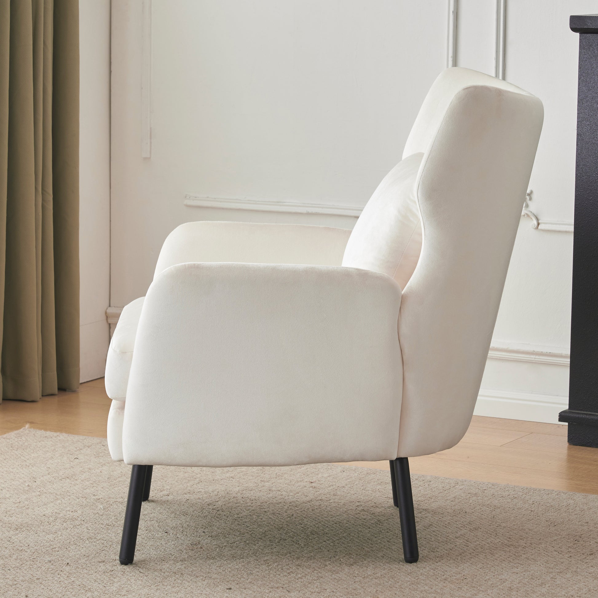 Plush cream velvet armchair with tapered black legs perfect for a modern living room