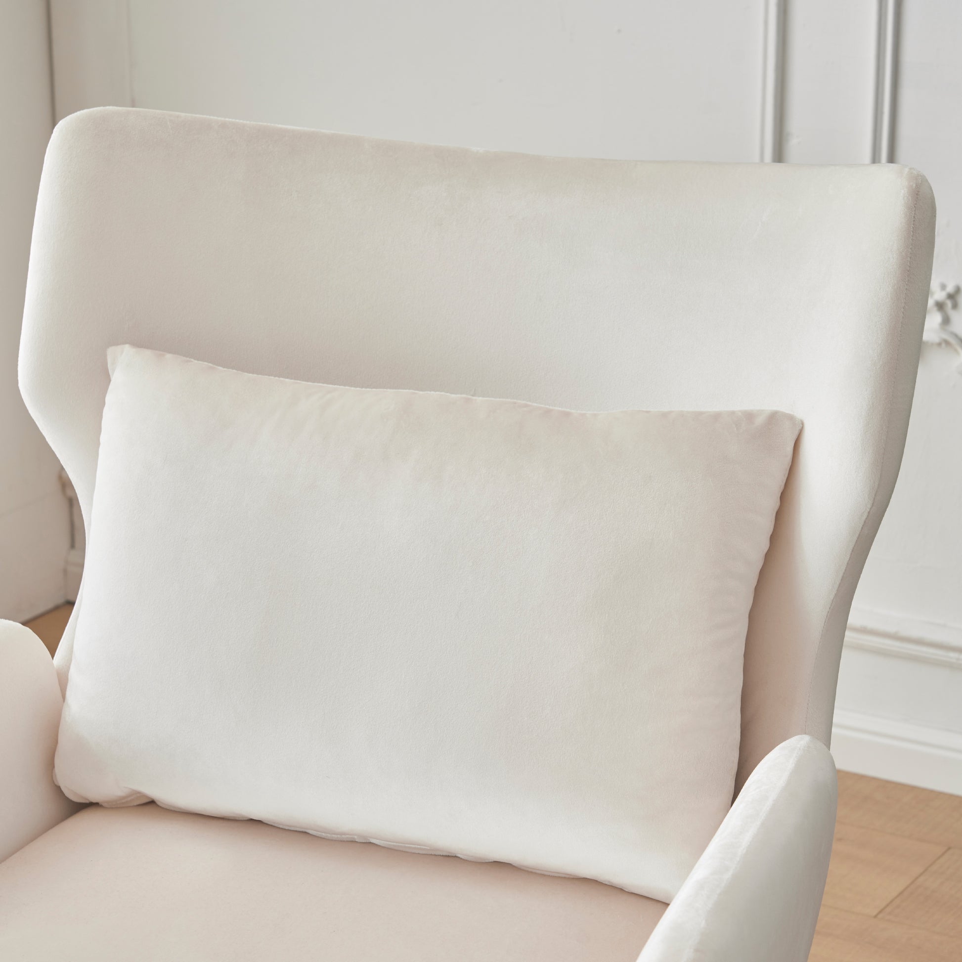 Cream velvet lumbar pillow on a plush armchair for comfortable home decor