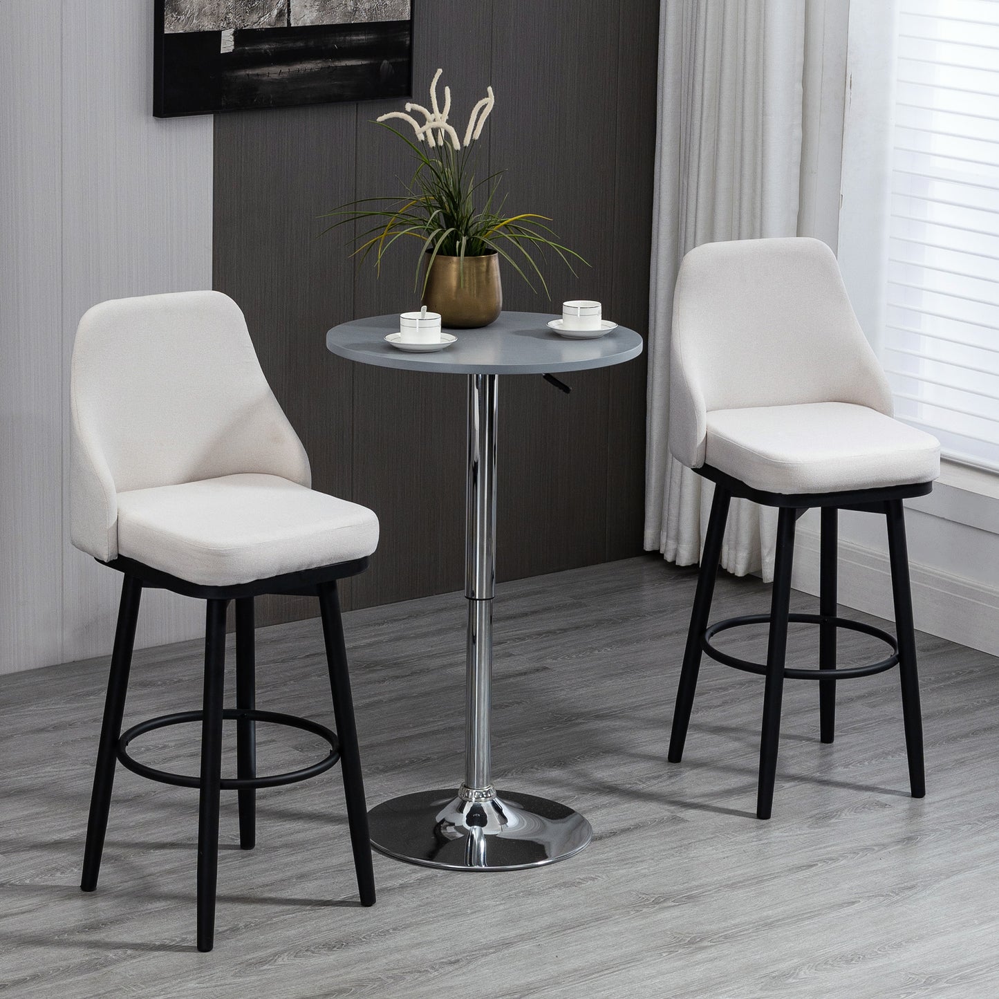 Cream upholstered bar stool with black wooden legs and a footrest ring ready for use