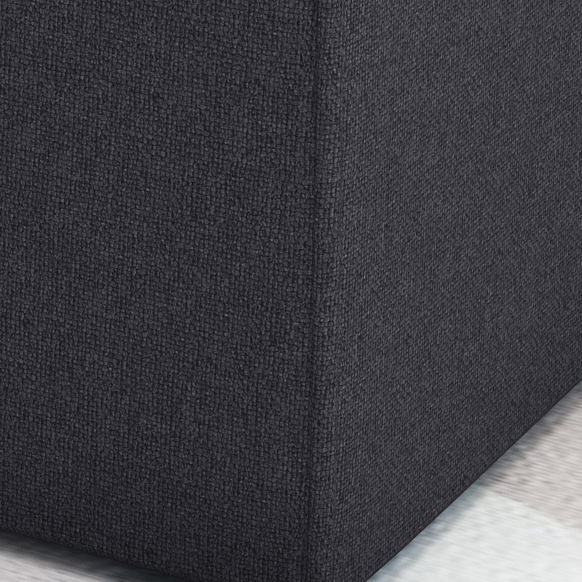 Dark gray textured fabric ottoman corner