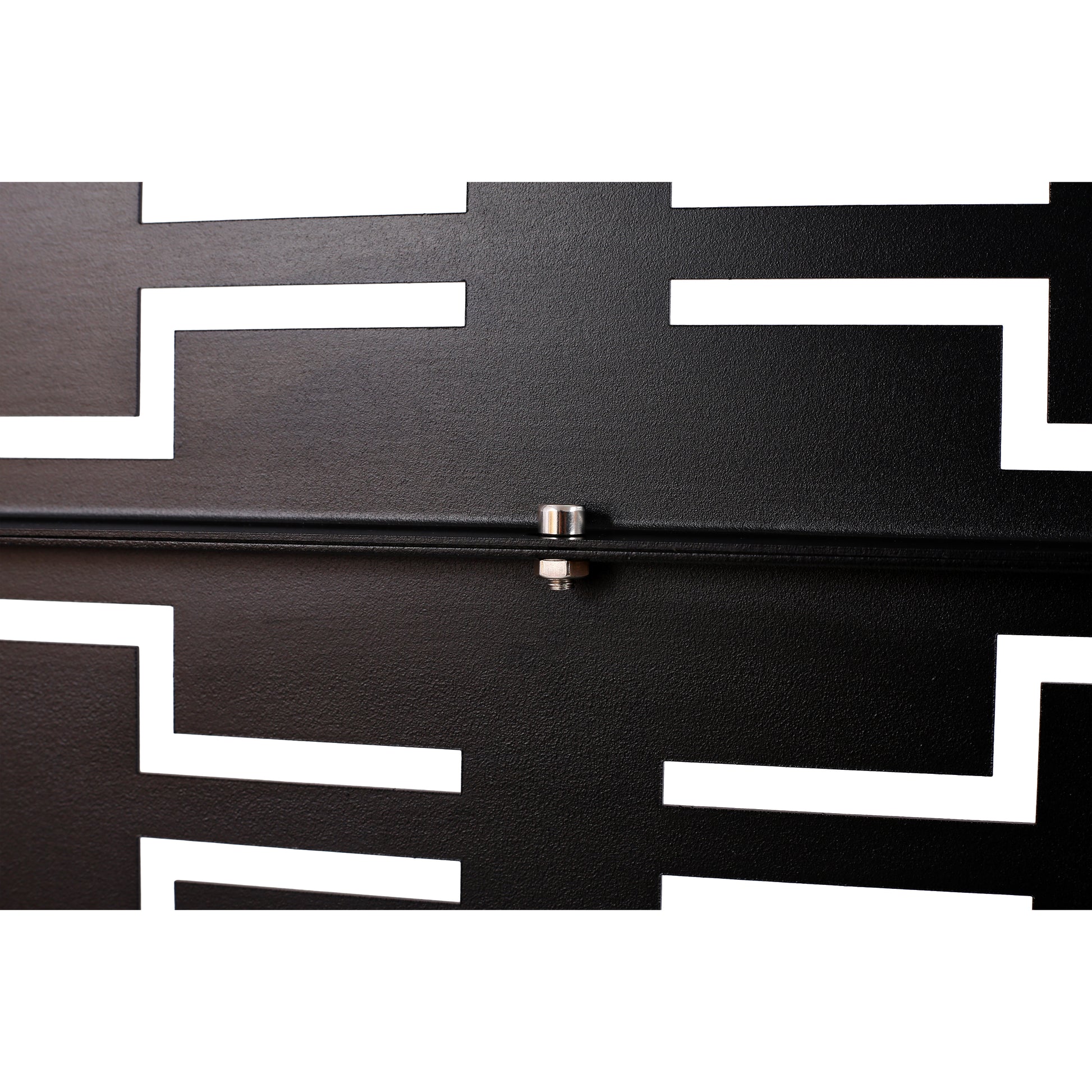 Closeup of textured black metal with a white geometric cutout pattern featuring a silver bolt