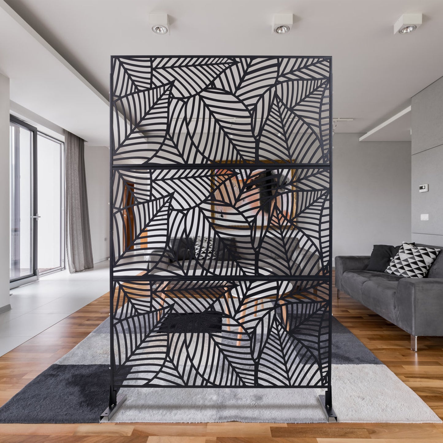 Black metal room divider screen with intricate leaf pattern