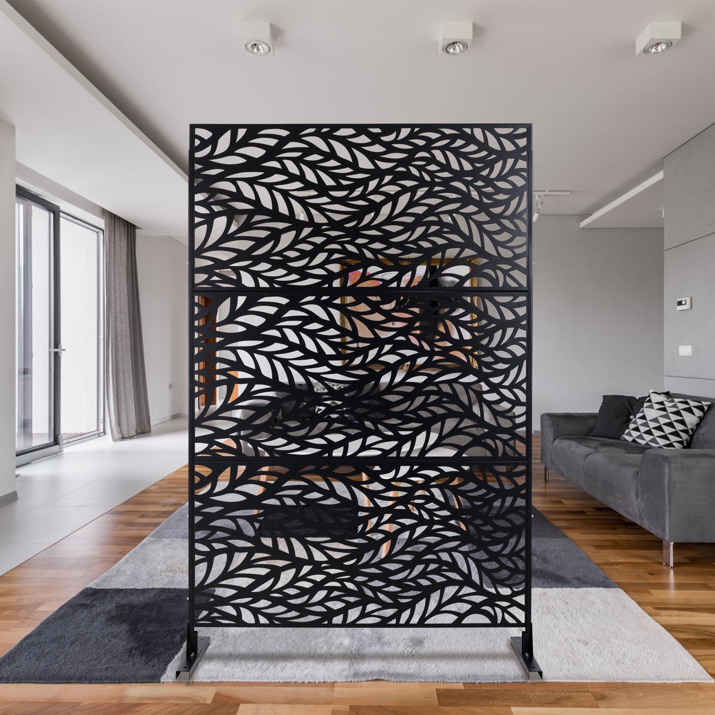 Decorative room divider screen with black metal frame and intricate leaf pattern