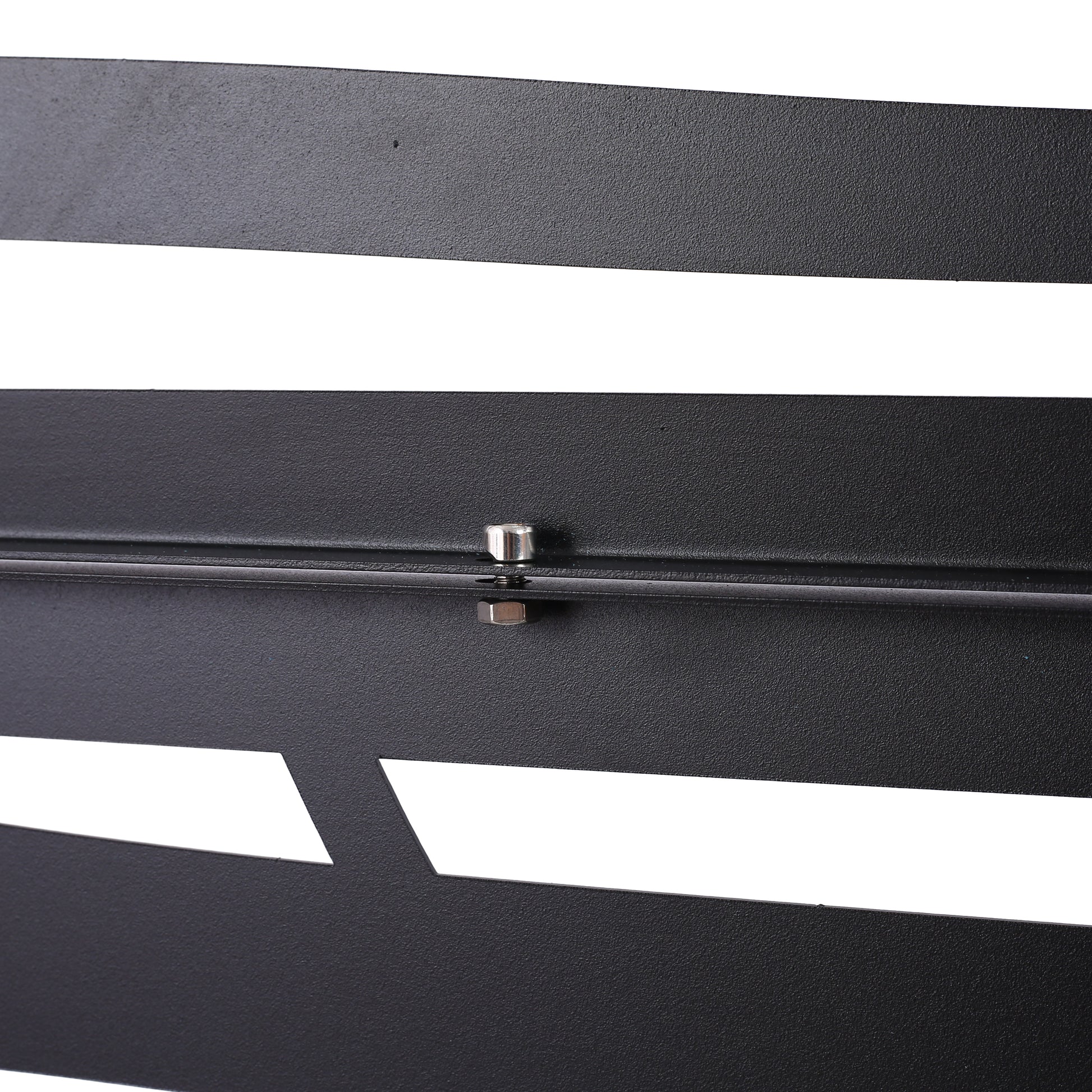 Textured black metal panel with geometric cutouts and silver bolt detail
