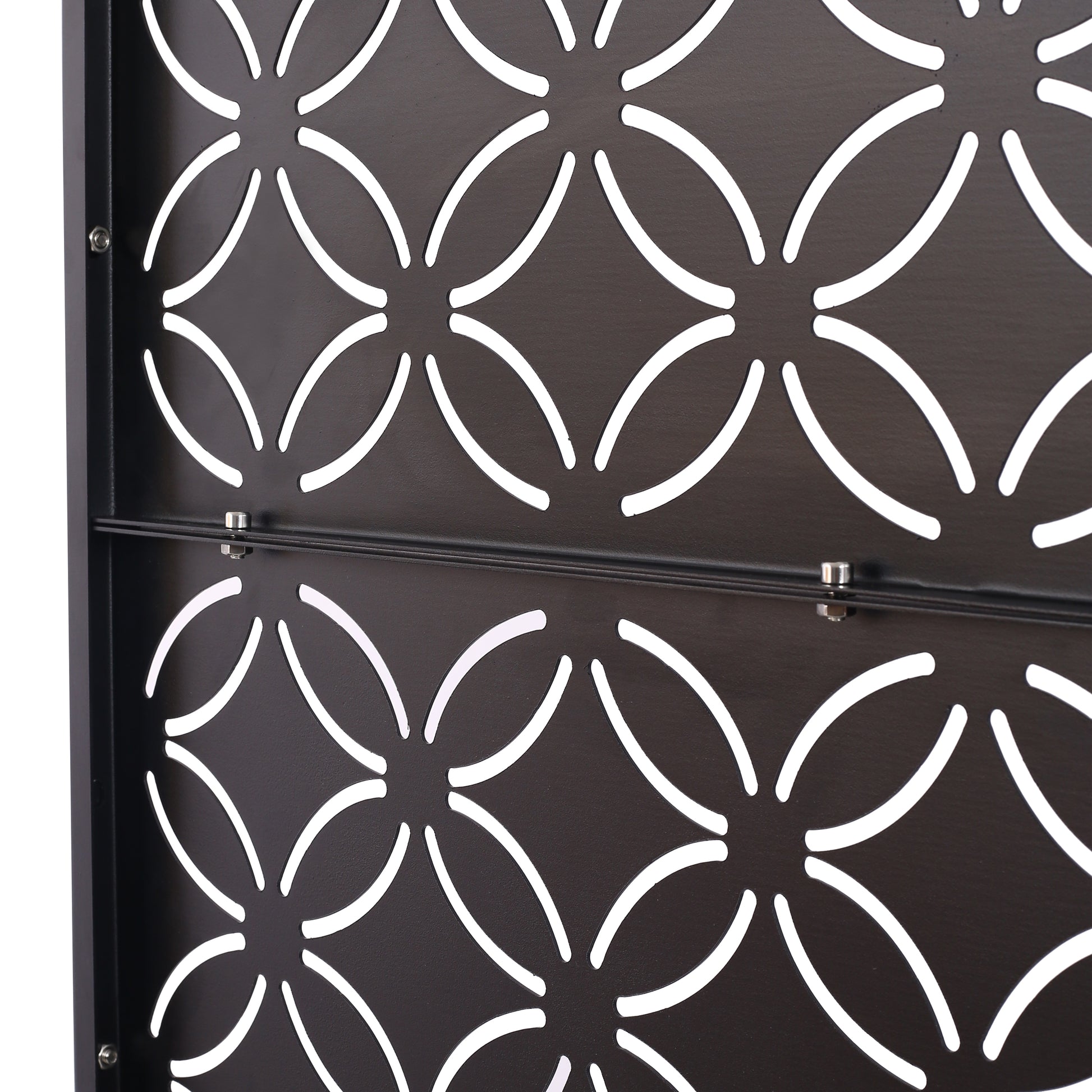 Dark brown metal decorative screen with a repeating quatrefoil pattern