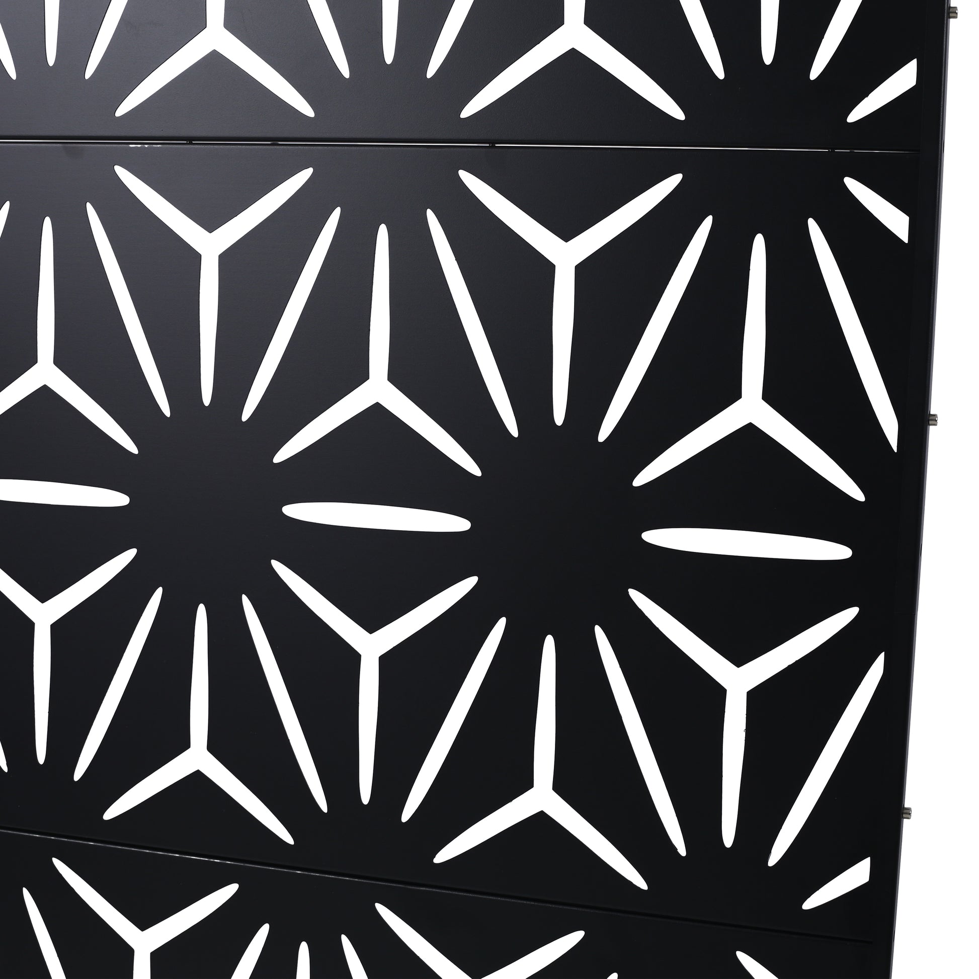 Black geometric metal screen with abstract starburst cutouts for outdoor privacy