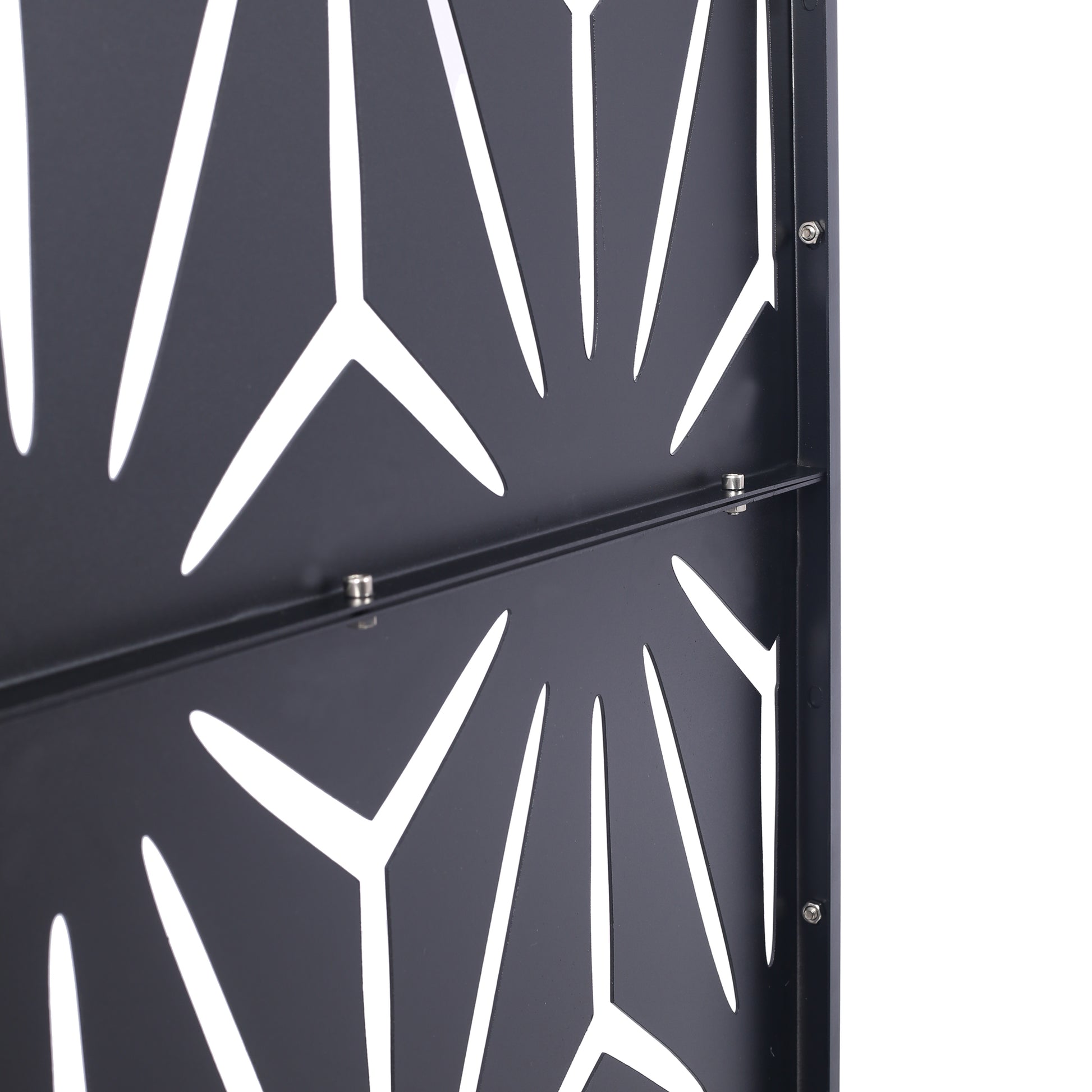 Black metal garden screen with abstract geometric cutouts and visible bolts