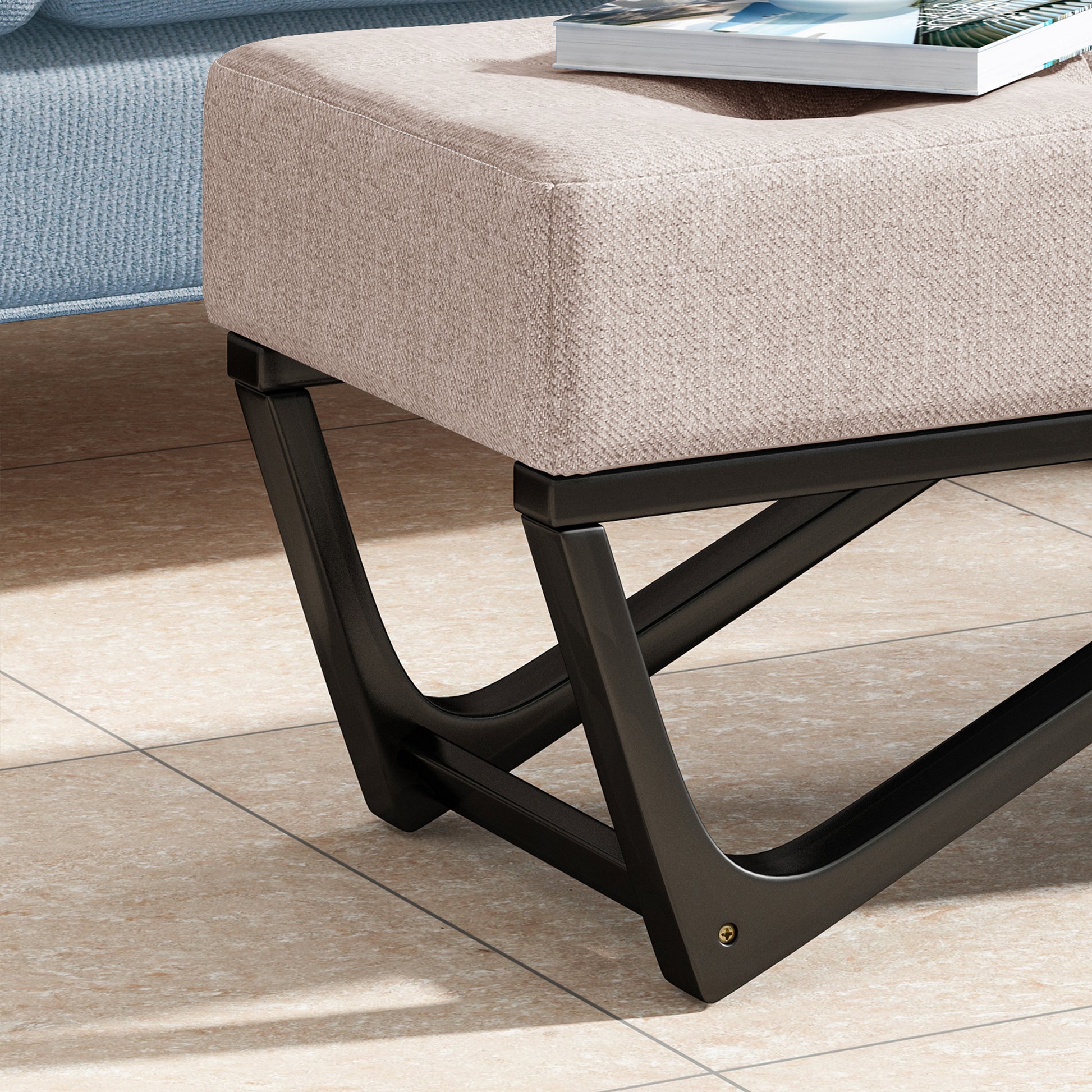 Beige upholstered ottoman with modern black metal legs perfect for living rooms