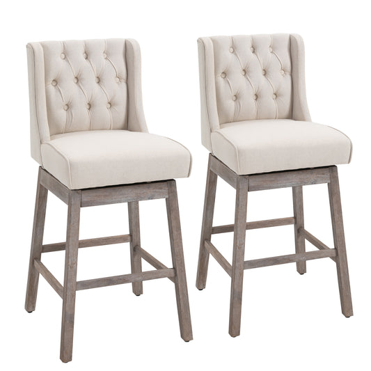 Pair of beige upholstered swivel bar stools with tufted backs and distressed wood legs
