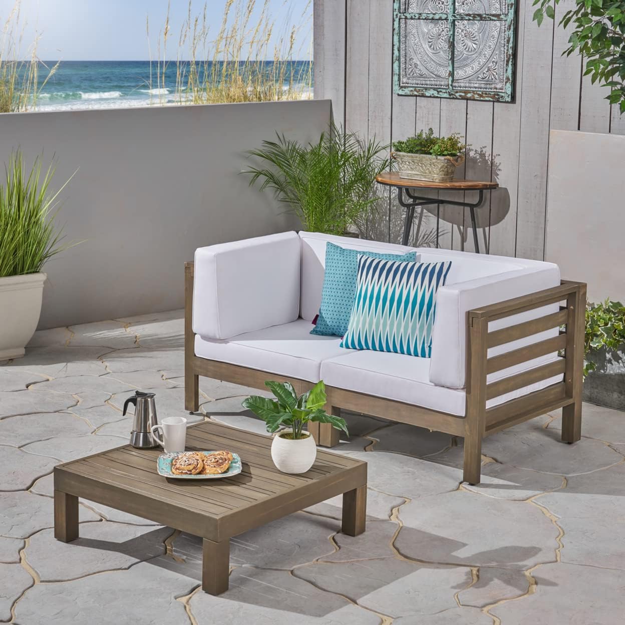 Modern outdoor sectional sofa with white cushions and teak wood frame