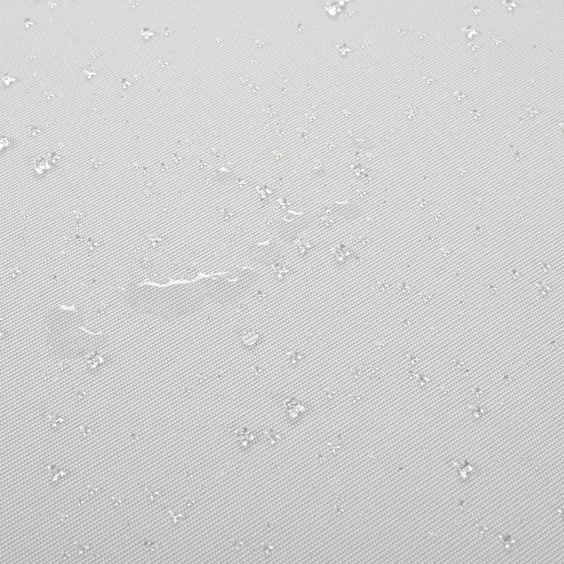 Light gray fabric with visible water beads demonstrating its waterproof quality