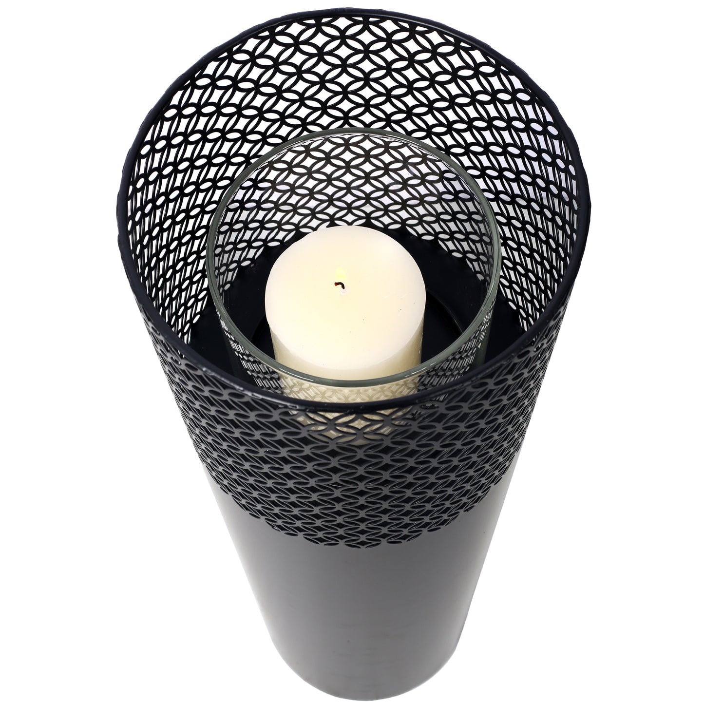 Black metal filigree lantern with glass insert and lit pillar candle for ambiance