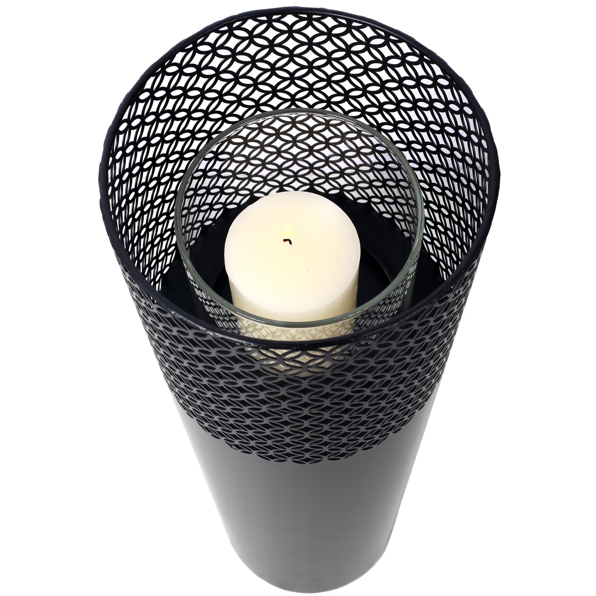Black metal filigree lantern with glass insert and lit pillar candle for ambiance