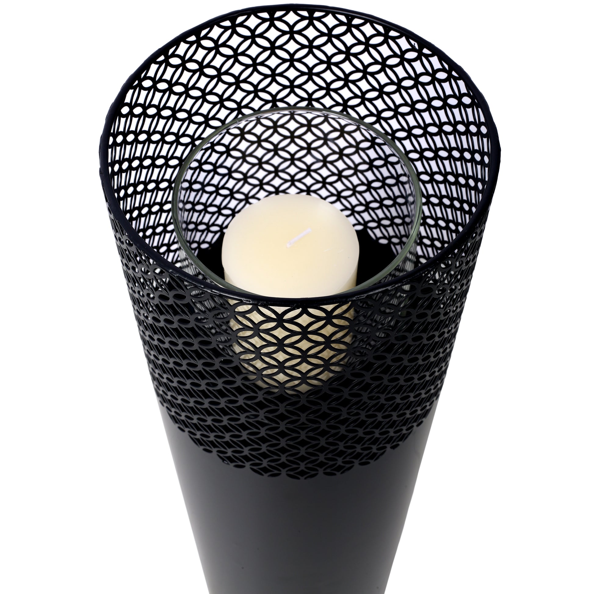 Black metal lantern with geometric cutouts holding a white pillar candle perfect for home decor