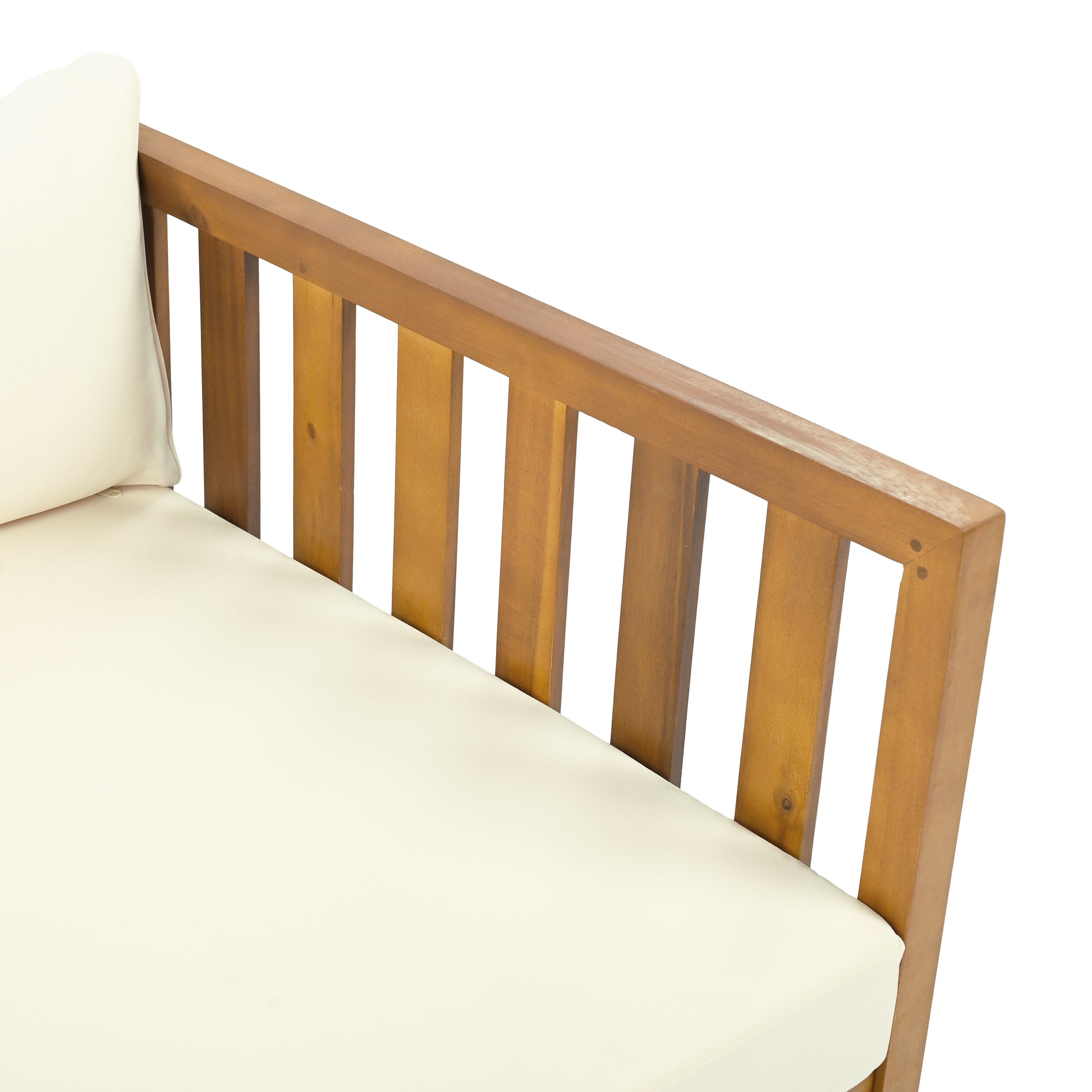 Corner detail of a light beige upholstered outdoor bench with a slatted wooden armrest